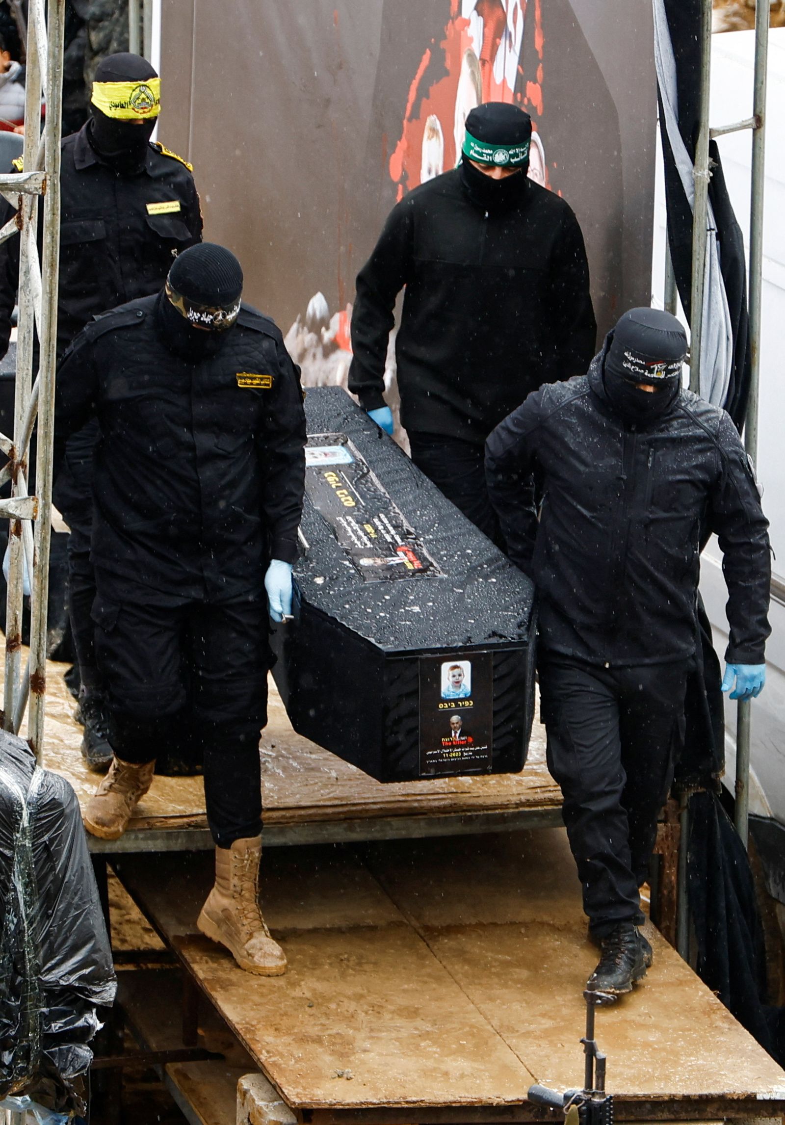 Palestinian militants carry a coffin on the day Hamas hands over deceased hostages Oded Lifschitz, Shiri Bibas and her two children Kfir and Ariel Bibas, seized during the deadly October 7, 2023 attack, to the Red Cross, as part of a ceasefire and hostages-prisoners swap deal between Hamas and Israel, in Khan Younis in the southern Gaza Strip February 20, 2025. REUTERS/Hatem Khaled