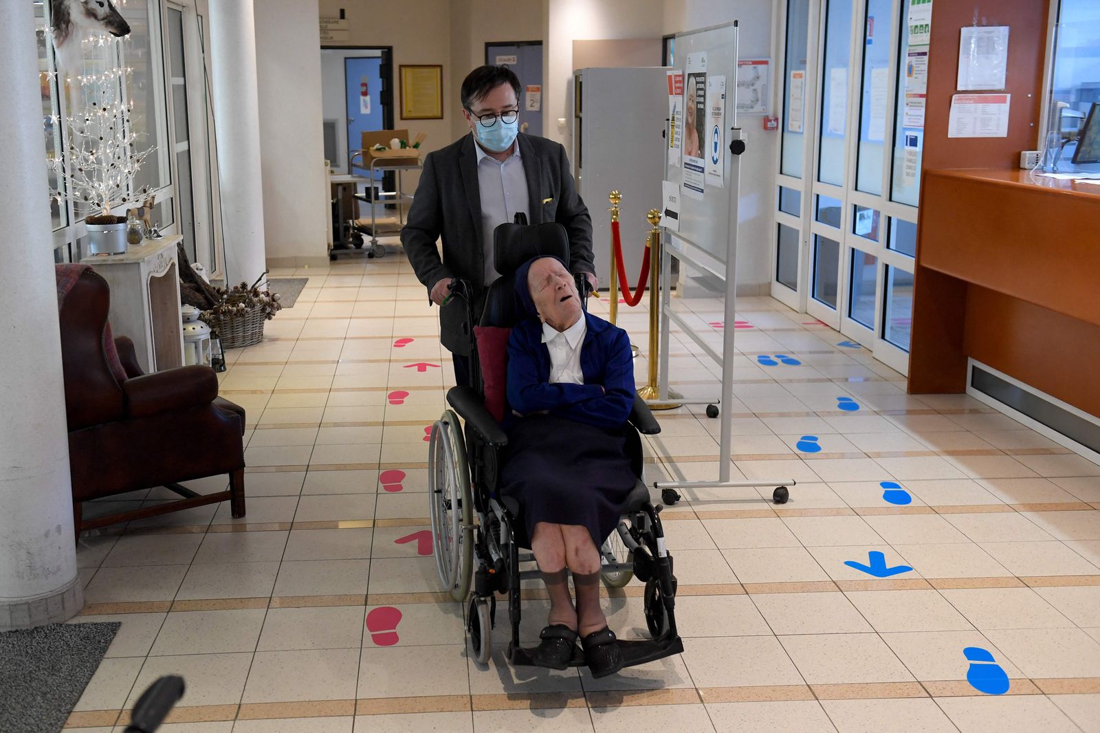 (FILES) In this file photo taken on February 10, 2021 Sister Andre, Lucile Randon in the registry of birth, the eldest French and European citizen, sits in a wheelchair, on the eve of her 117th birthday - born on February 11, 1904 - in an EHPAD (Housing Establishment for Dependant Elderly People) in Toulon, southern France, where she has been living since 2009. - Sister Andr�, a 118-year-old French nun, already the oldest person in France, has become the new probable oldest person in the world, after the death announced on April 25, 2022 of Kane Tanaka, a 119-year-old Japanese woman. (Photo by NICOLAS TUCAT / AFP) - AFP