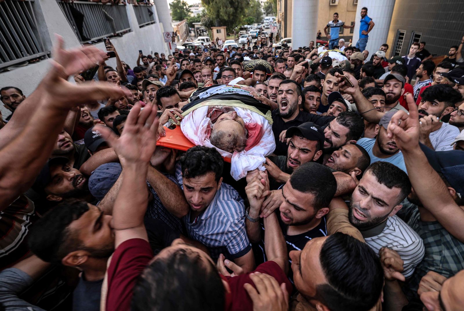 Palestinian mourners carry the body of Islamic Jihad commander Tayseer al-Jabari, killed earlier in an Israeli air strike, during his funeral in Gaza City on August 5, 2022. - The senior militant was among more than 15 people killed in Israeli air strikes on the Gaza Strip today, prompting the militant group to warn Israel has made a 