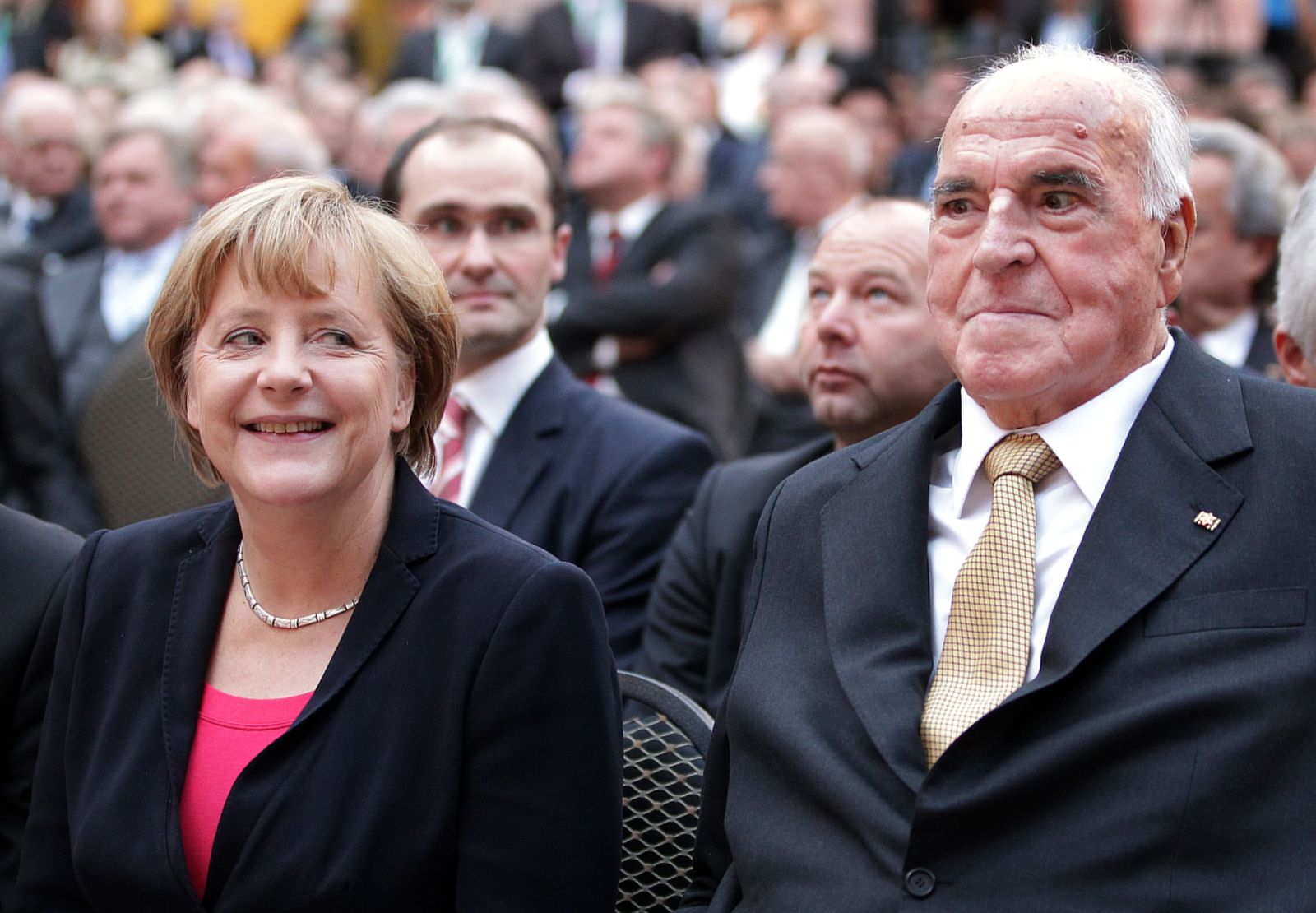 (FILES) This file photo taken on September 27, 2012 shows former German Chancellor Helmut Kohl (R) and German Chancellor Angela Merkel sitting in the first row at the German Historical Museum (Deutsches Historisches Museum) in Berlin during celebrations of the 30th anniversary of Kohl being elected Chancellor, organised by the Konrad-Adenauer-Stiftung foundation in honor of Kohl's political achievements. - In power so long she has been dubbed Germany's 