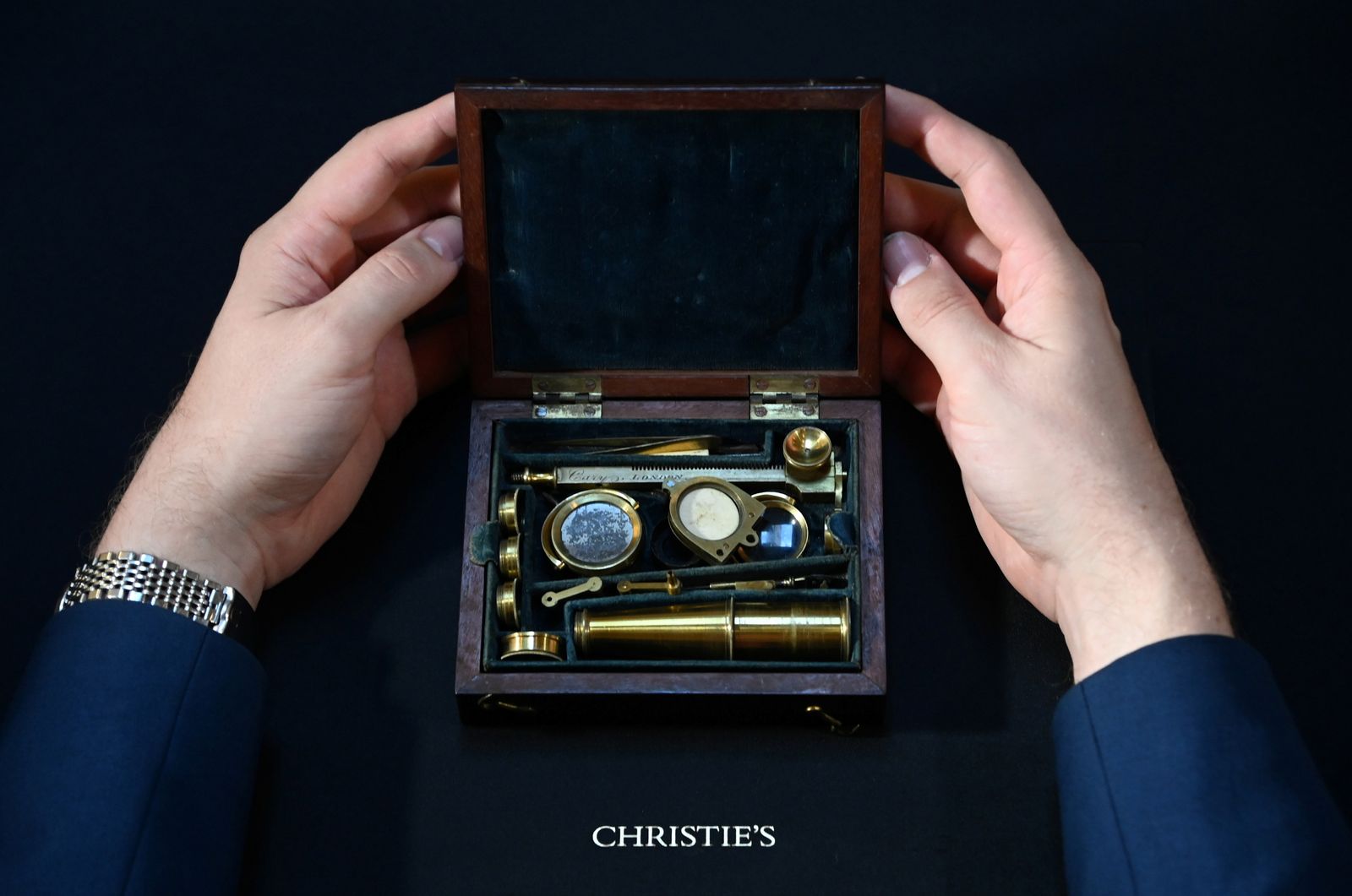 Darwin Family Microscope, owned and used by the English naturalist, Charles Darwin, demonstrated ahead of auction at Christie's, London - REUTERS