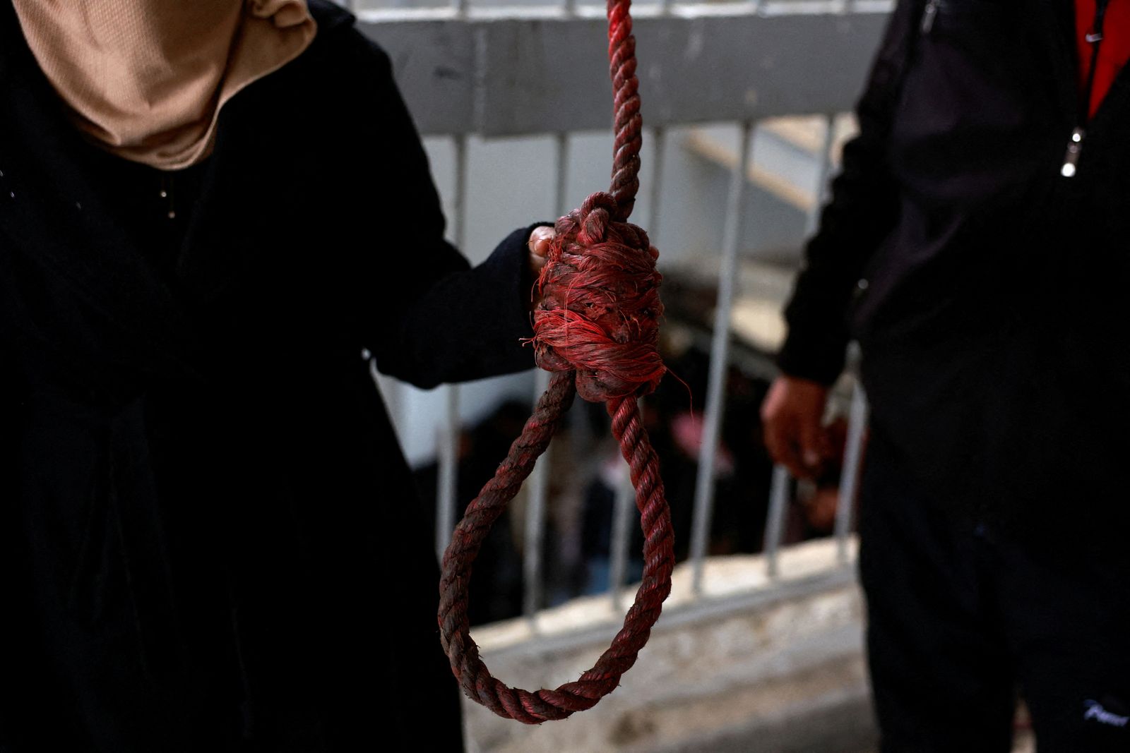 Hayat al-Turki, 27, holds a gallow inside Sednaya prison, which was known as a slaughterhouse under Syria's Bashar al-Assad rule, as she searches the prison in the hope of finding her relatives, after rebels seized the capital and announced that they have ousted Syria's Bashar al-Assad, in Sednaya, Syria, December 11, 2024. REUTERS/Ammar Awad      TPX IMAGES OF THE DAY