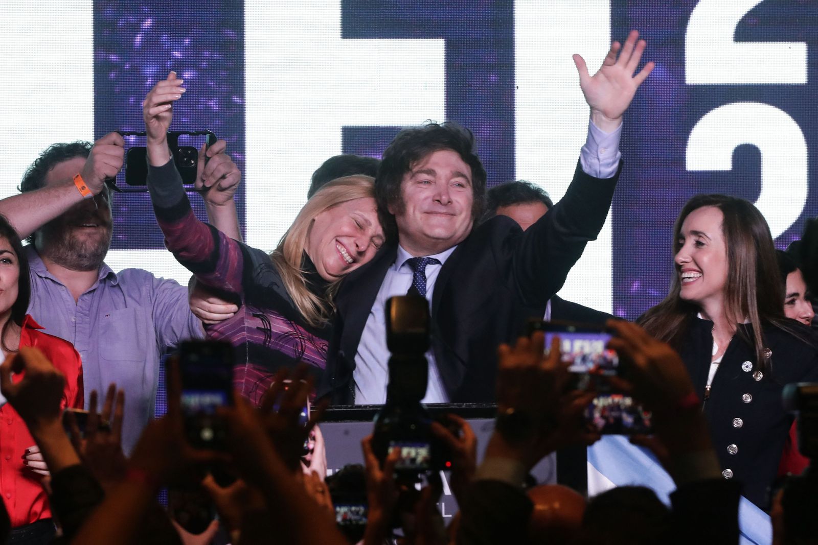 Argentine far-right libertarian economist and presidential candidate Javier Milei celebrates the results of the primary elections with his sister Karina Milei at Milei's headquarters in Buenos Aires on August 13, 2023. The far-right libertarian economist Javier Milei gets 32.31% of the votes in the primaries for the Argentine presidential election, and becomes the protagonist of this election that will contest the former Security Minister Patricia Bullrich and the Economy Minister Sergio Massa. (Photo by ALEJANDRO PAGNI / AFP)