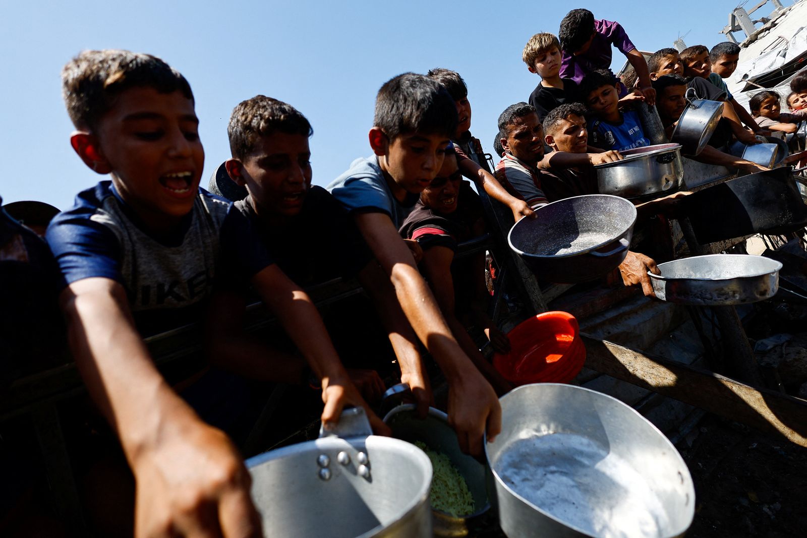 Palestinians wait to receive food from a charity kitchen after the global hunger monitor, Integrated Food Security Phase Classification (IPC), said that Gaza City and surrounding areas are officially suffering from famine that will likely spread, in Gaza City, August 28, 2025. REUTERS/Mahmoud Issa