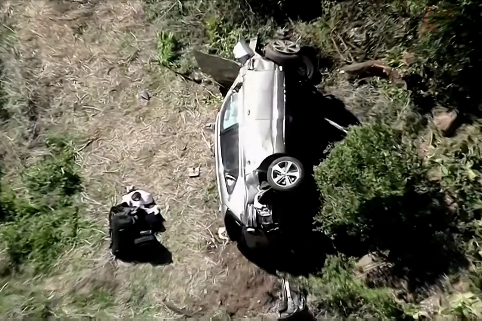 The vehicle of golfer Tiger Woods lies on its side after being involved in a single-vehicle accident in Los Angeles - via REUTERS