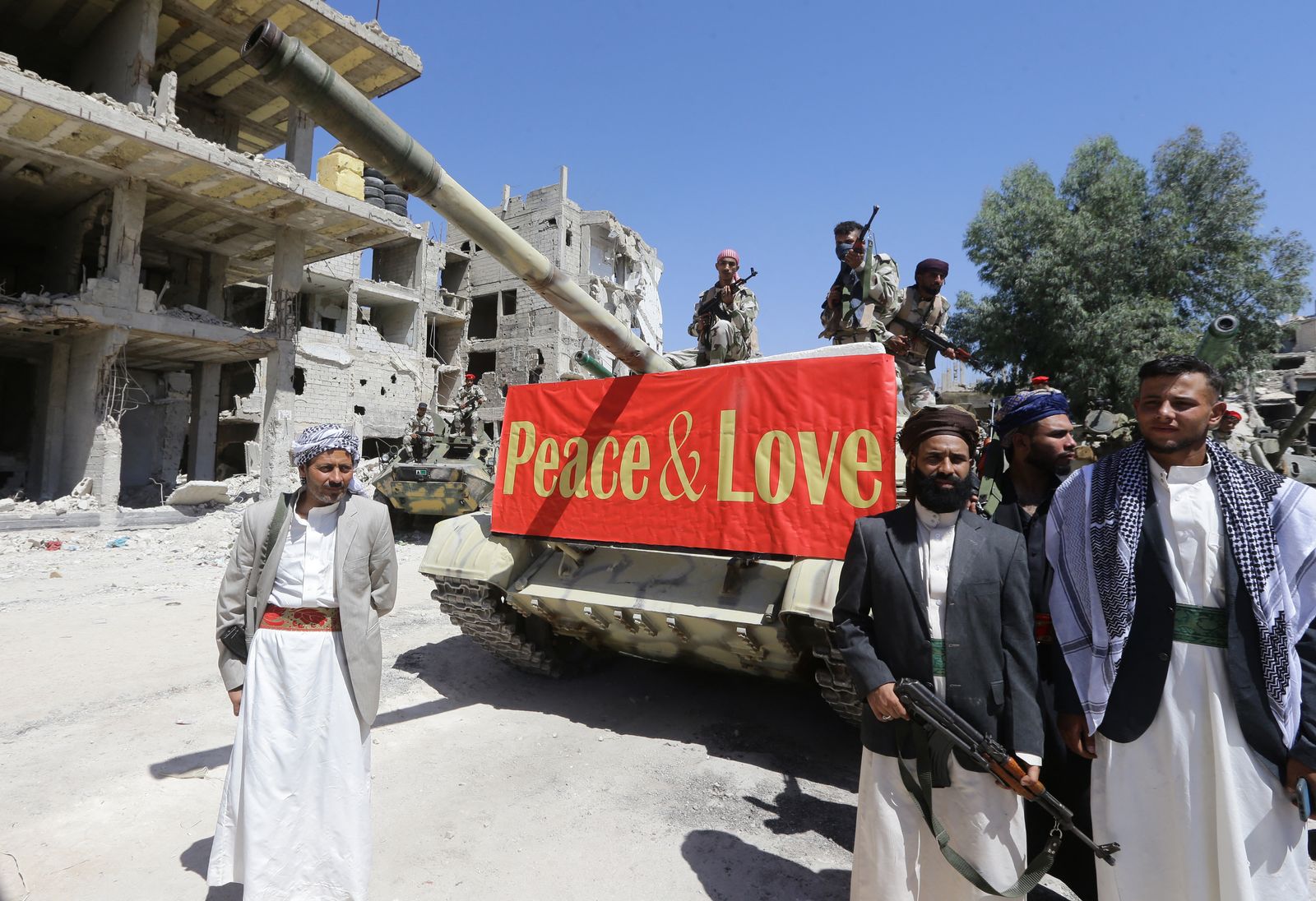 Actors are pictured in the Hajar al-Aswad neighbourhood of the Syrian capital Damascus on July 14, 2022, during the filming of a scene in a film titled 