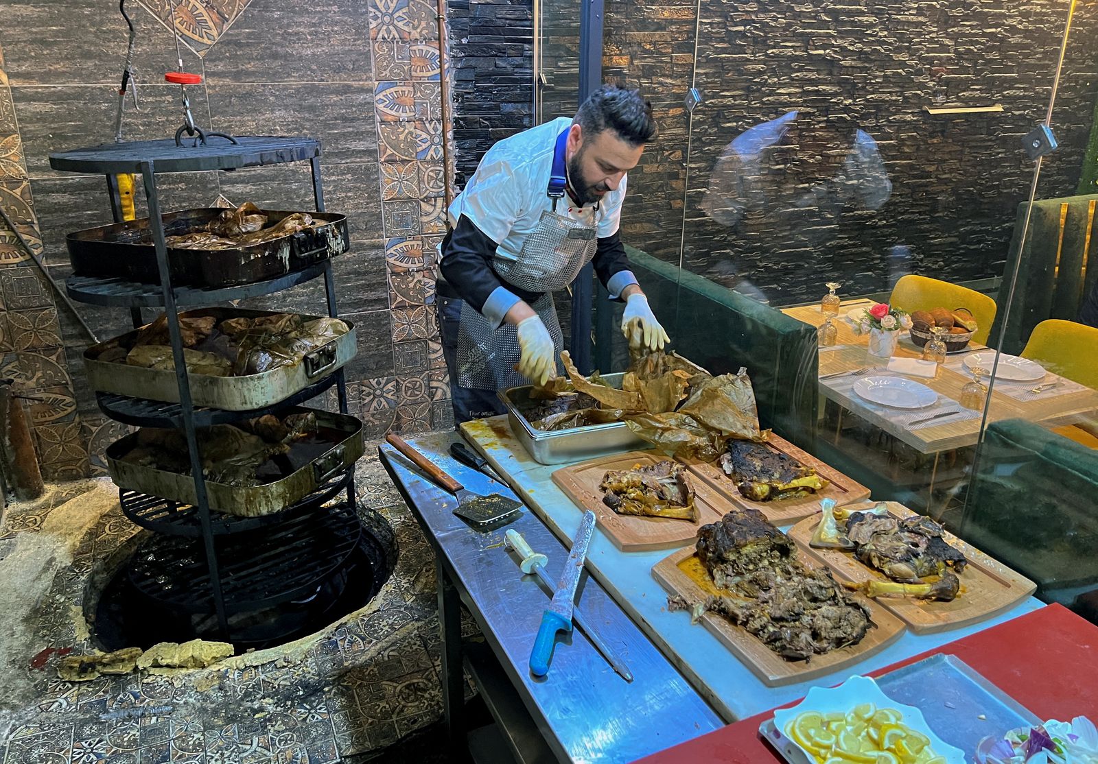 Restaurant owner, Amer Halimi, prepares traditional 'Merdouma' dish in Constantine - REUTERS