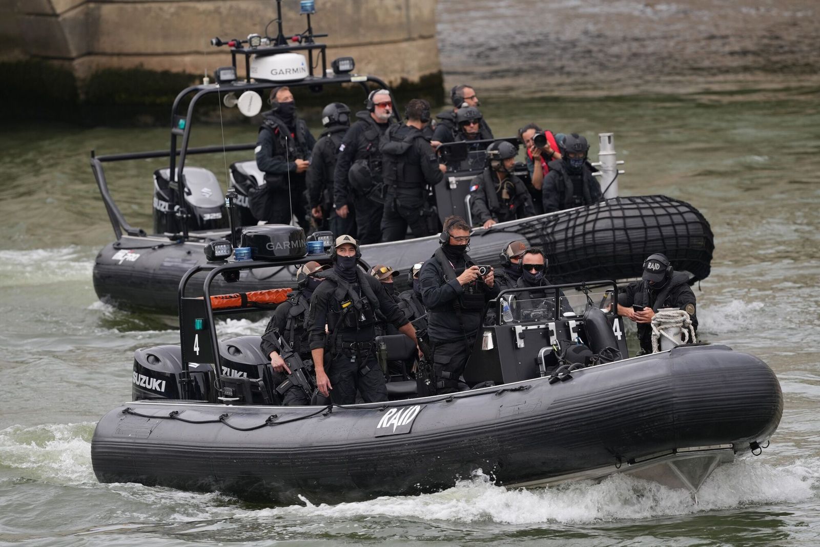 French security forces on rigid inflatable boats patrol the River Seine ahead of the opening ceremony of the Paris 2024 Olympic Games in Paris, France, on Friday, July 26, 2024. The Paris Summer Olympics include among the most public and controversial rollouts ever of algorithmic video surveillance, an AI event-security technology that uses machine learning to analyze video footage in real time to detect�and even predict�threats and other anomalies. Photographer: Nathan Laine/Bloomberg