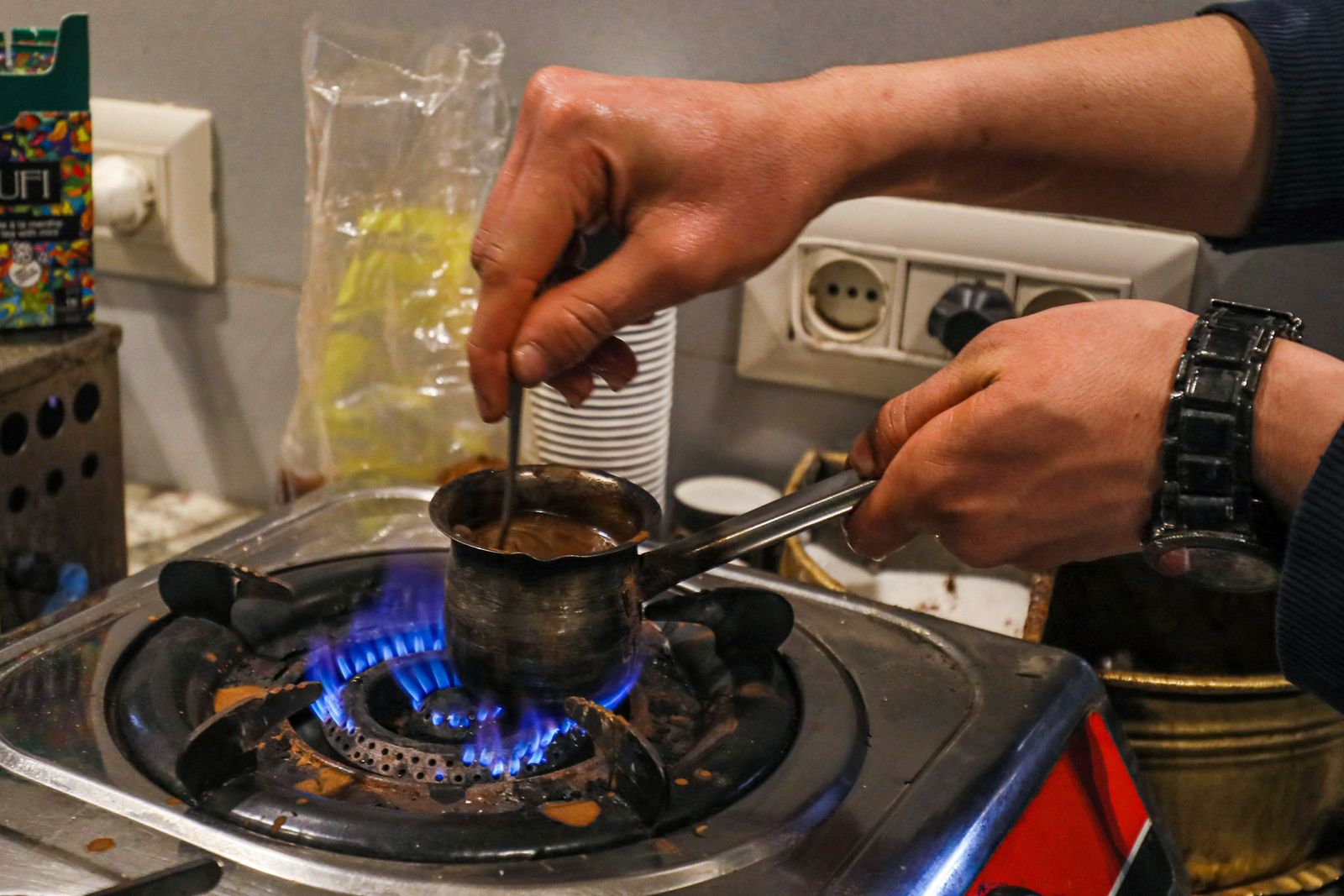 In this picture taken on March 16, 2023, a barista prepares coffee at a cafe in Tripoli. - Italy left a deep cultural mark on Libya, the only Arab country it colonised: a national love of espresso. But as the fasting month of Ramadan approaches, Libyans are preparing to go without. Throughout the Islamic holy month, which is due to begin this week, observant Muslims are expected to refrain from eating and drinking from dawn to dusk. (Photo by Mahmud TURKIA / AFP) - AFP