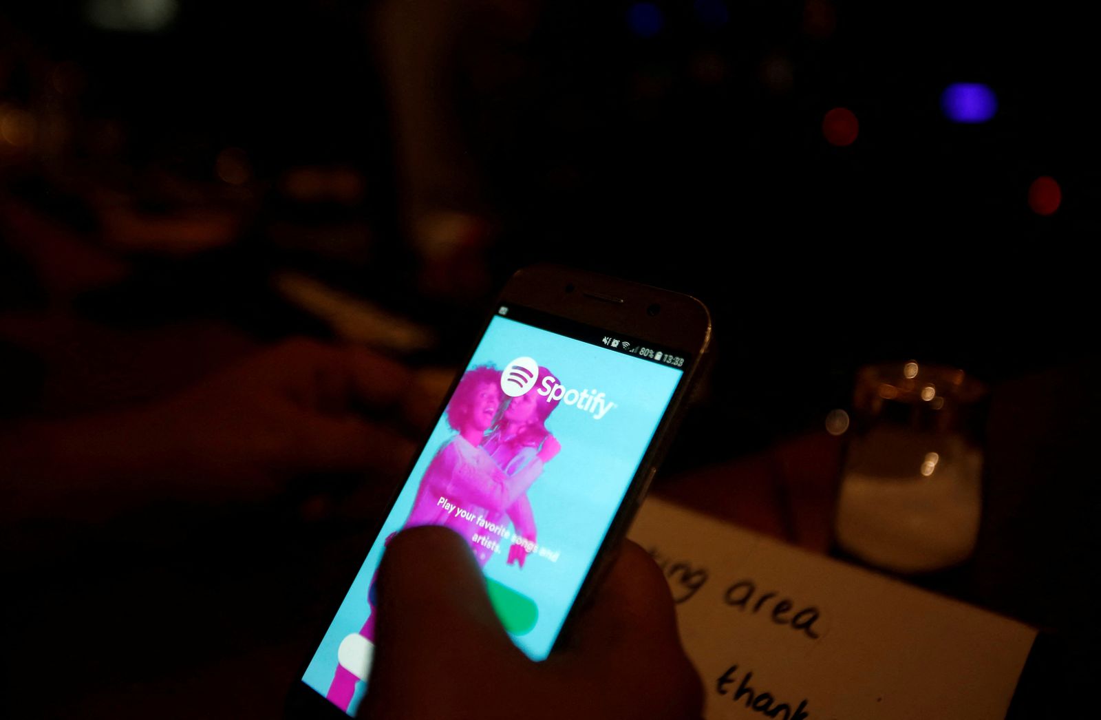 FILE PHOTO: Palestinian musician Firas Harb uses Spotify app on his mobile phone in Beit Sahour, in the occupied West Bank