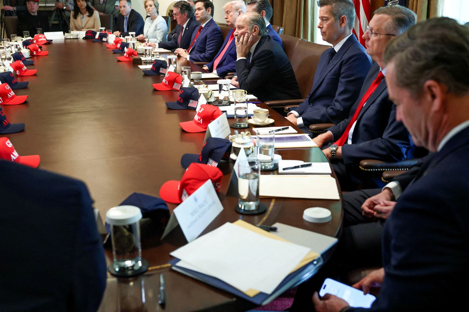 FILE PHOTO: U.S. National Security Advisor Mike Waltz checks his mobile phone while attending a cabinet meeting held by U.S. President Donald Trump at the White House in Washington, D.C., U.S., April 30, 2025. REUTERS/Evelyn Hockstein/File Photo