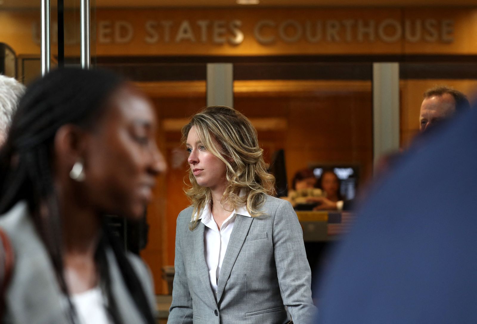 (FILES) In this file photo taken on June 28, 2019 former Theranos CEO Elizabeth Holmes (C) leaves the Robert F. Peckham U.S. Federal Court in San Jose, California after appearing for a status hearing. - A female entrepreneur whose multi-billion dollar start-up looked set to revolutionize medical testing, before it crashed and burned in a blaze of fraud claims, goes on trial next month. When she launched the diagnostics company Theranos in 2003, at the age of just 19, the charismatic Elizabeth Holmes promised results that were faster and cheaper than traditional laboratories, running an analytical gamut on just a few drops of blood. (Photo by JUSTIN SULLIVAN / GETTY IMAGES NORTH AMERICA / AFP) - AFP