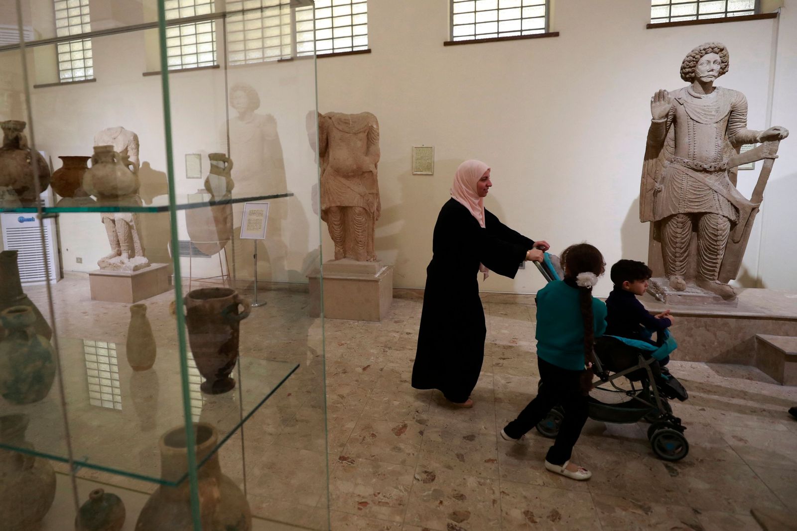 People visit Baghdad's national museum on February, 24, 2023, after it opened its doors to receive visitors free of charge every Friday. - Closed for three years as of 2019 due to demonstrations and then the Covid-19 pandemic, the museum reopened in March 2022. (Photo by AHMAD AL-RUBAYE / AFP) - AFP
