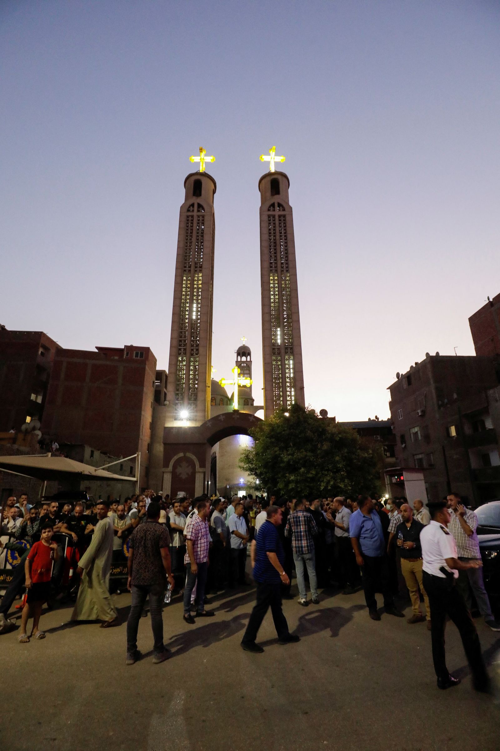 People gather during the funeral of victims, who died due to the fire that broke out at the Abu Sifin church, outside the Church of the Blessed Virgin Mary at Warraq Al Arab district in Giza Governorate, Egypt, August 14, 2022. REUTERS/Mohamed Abd El Ghany - REUTERS