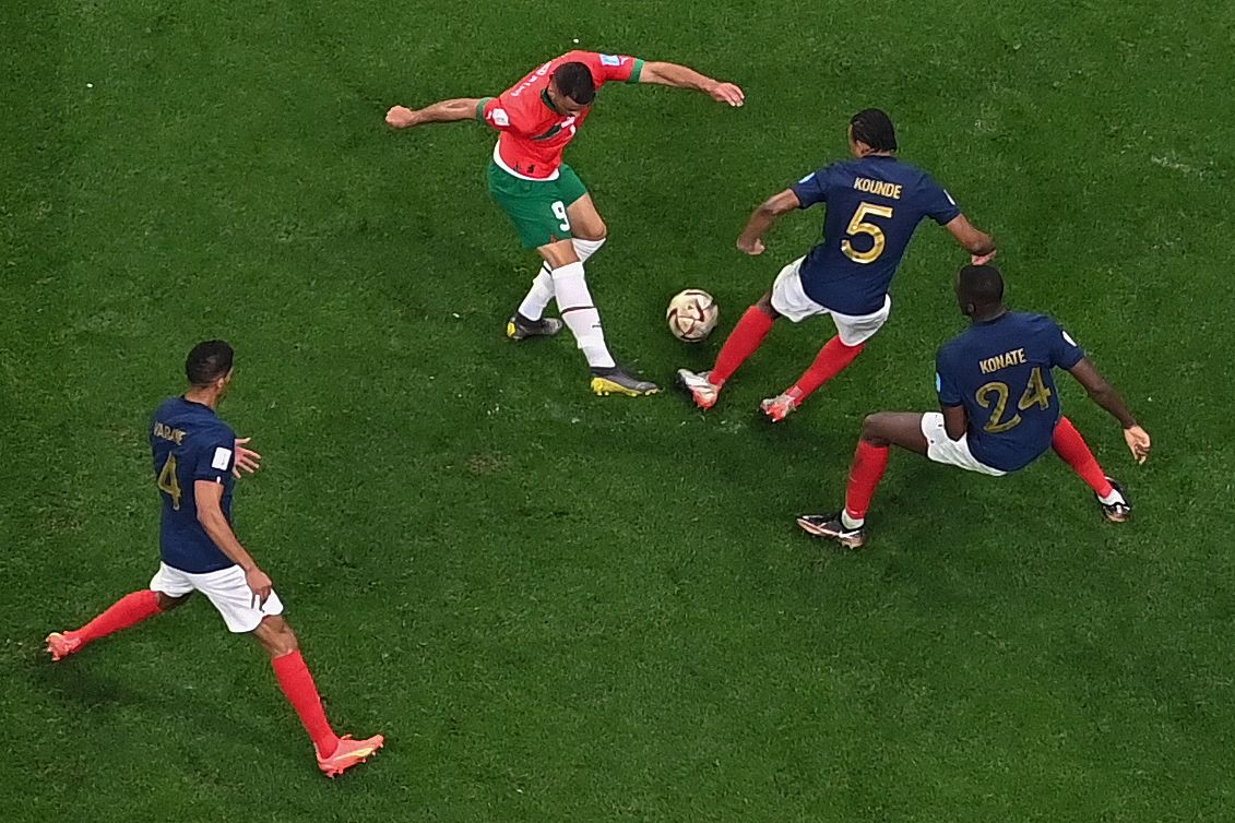 Morocco's forward #09 Abderrazak Hamdallah and France's defender #05 Jules Kounde fight for the ball during the Qatar 2022 World Cup football semi-final match between France and Morocco at the Al-Bayt Stadium in Al Khor, north of Doha on December 14, 2022. (Photo by Anne-Christine POUJOULAT / AFP) - AFP