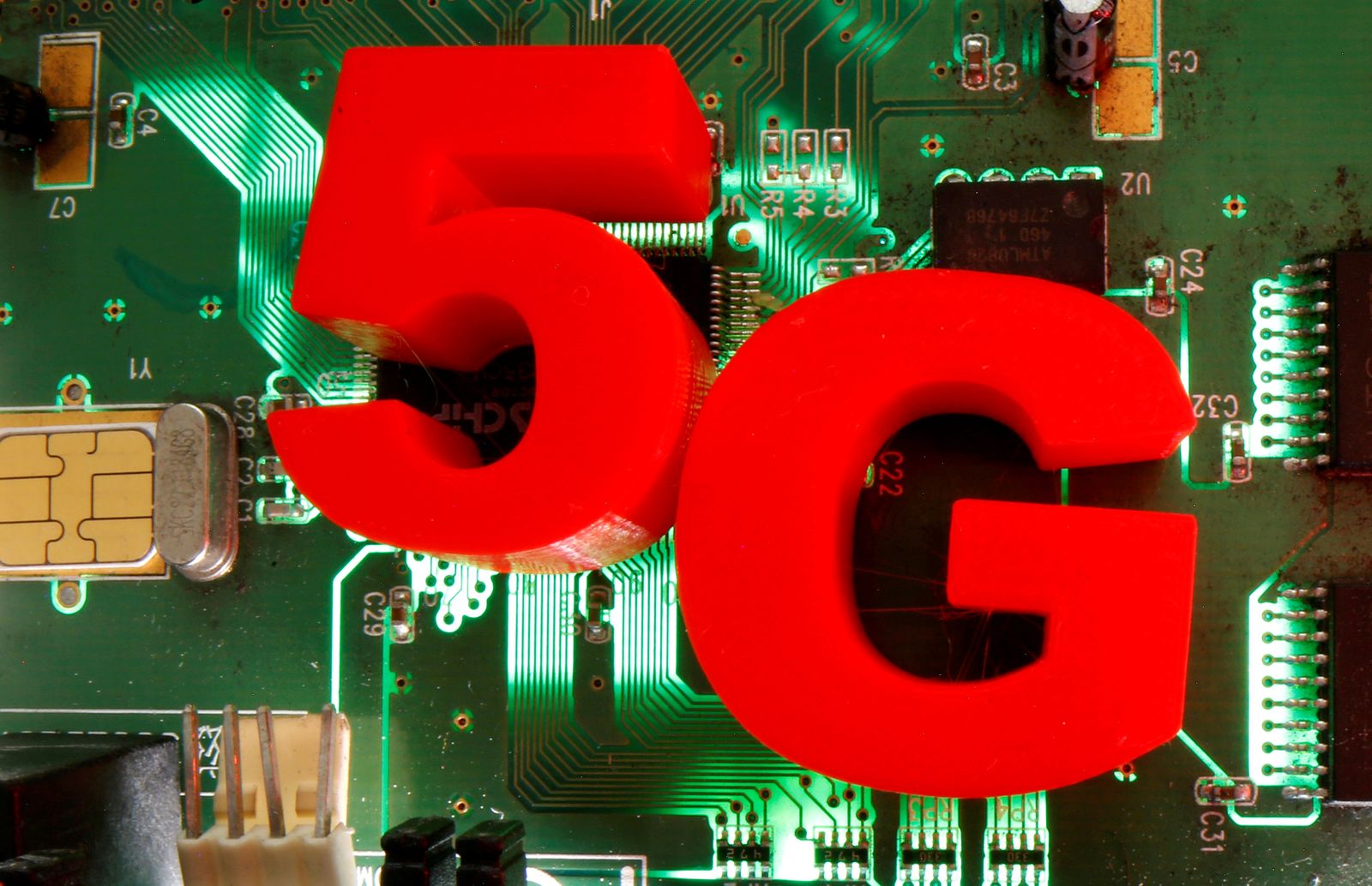 FILE PHOTO: 3d printed objects representing 5G are put on a motherboard in this picture illustration - REUTERS