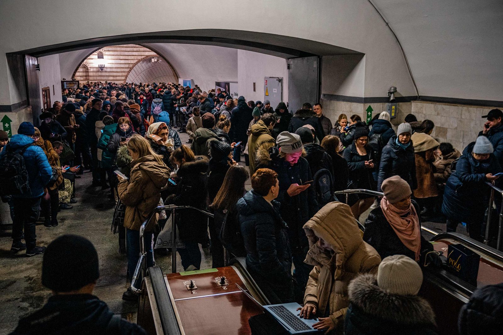 TOPSHOT - Civilians take shelter inside a metro station during air raid alert in the centre of Kyiv on December 16, 2022, amid the Russian invasion of Ukraine. - A fresh barrage of Russian strikes hit cities across Ukraine early on December 16, 2022 cutting water and electricity in major cities and piling pressure on Ukraine's grid with temperatures belowing freezing. (Photo by Dimitar DILKOFF / AFP) - AFP