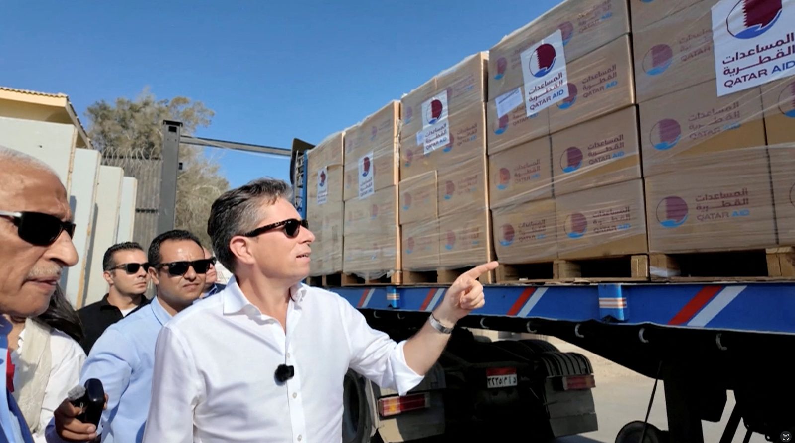 United Nations' Under-Secretary-General for Humanitarian Affairs and Emergency Relief Coordinator at the Office for the Coordination of Humanitarian Affairs (OCHA) Tom Fletcher points at a truck loaded with humanitarian aid as it is on its way to Gaza, after a ceasefire between Israel and Hamas in Gaza went into effect, at Rafah Crossing at the Egypt-Gaza border, in Rafah, Egypt, October 16, 2025 in this screengrab taken from a handout video. OCHA/Handout via REUTERS    THIS IMAGE HAS BEEN SUPPLIED BY A THIRD PARTY. MANDATORY CREDIT.