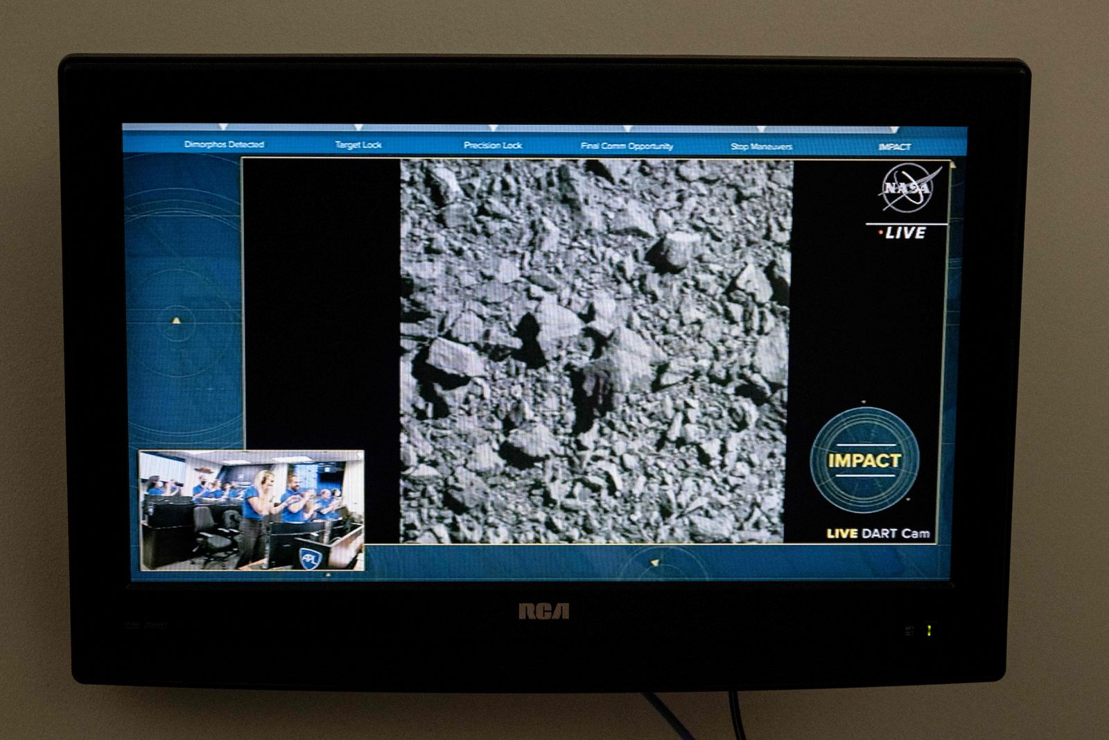 A television at NASA's Kennedy Space Center in Cape Canaveral, Florida, captures the final images from the Double Asteroid Redirection Test (DART) as it smashes into the asteroid Dimorphos on September 26, 2022. - NASA's DART spaceship on September 26 struck the moonlet asteroid Dimorphos, in a historic test of humanity's ability to prevent a cosmic object devastating life on Earth. (Photo by Jim WATSON / AFP) - AFP