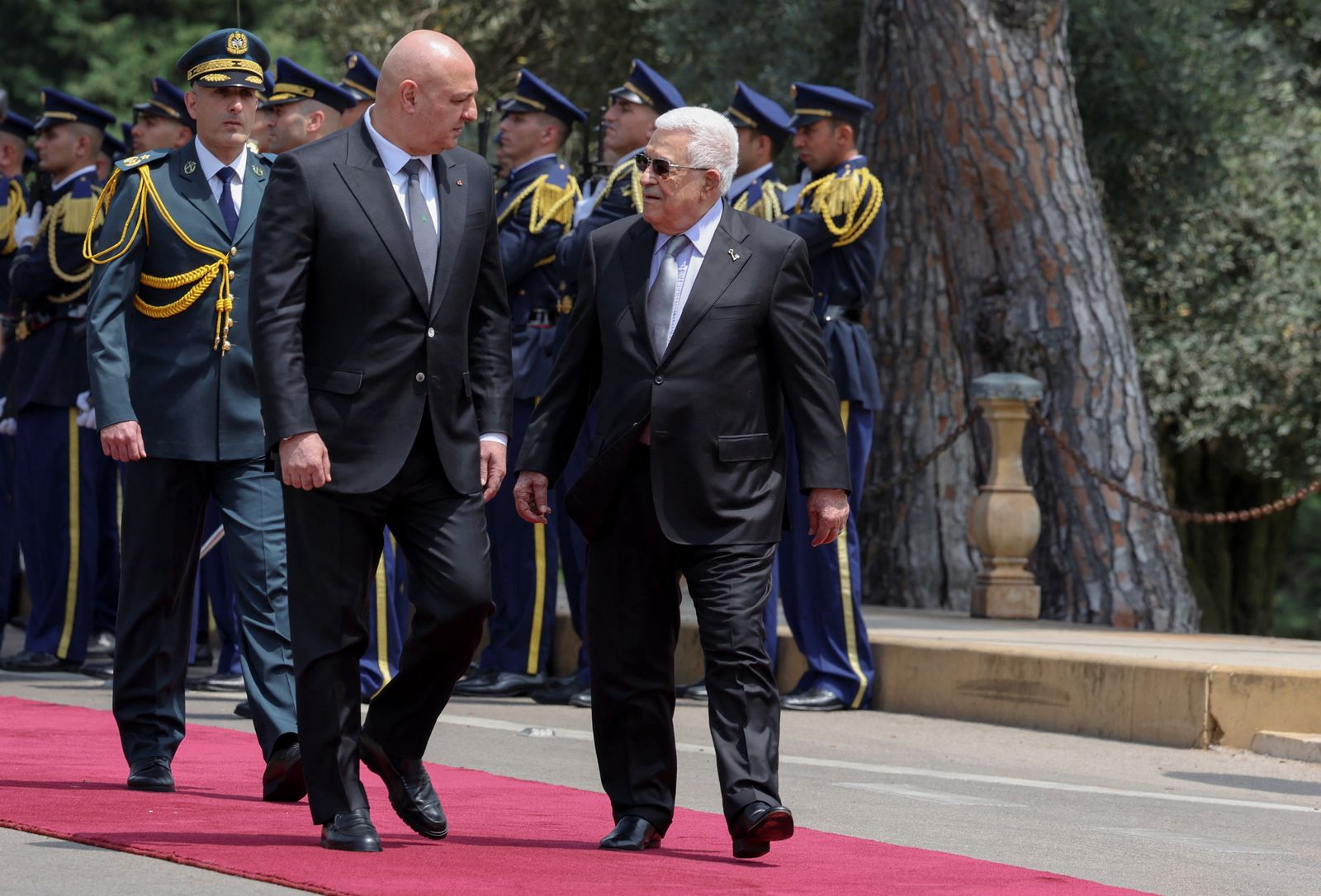 Lebanese President Joseph Aoun and Palestinian President Mahmoud Abbas review the honor guard at the presidential palace in Baabda, Lebanon May 21, 2025. REUTERS/Mohamed Azakir