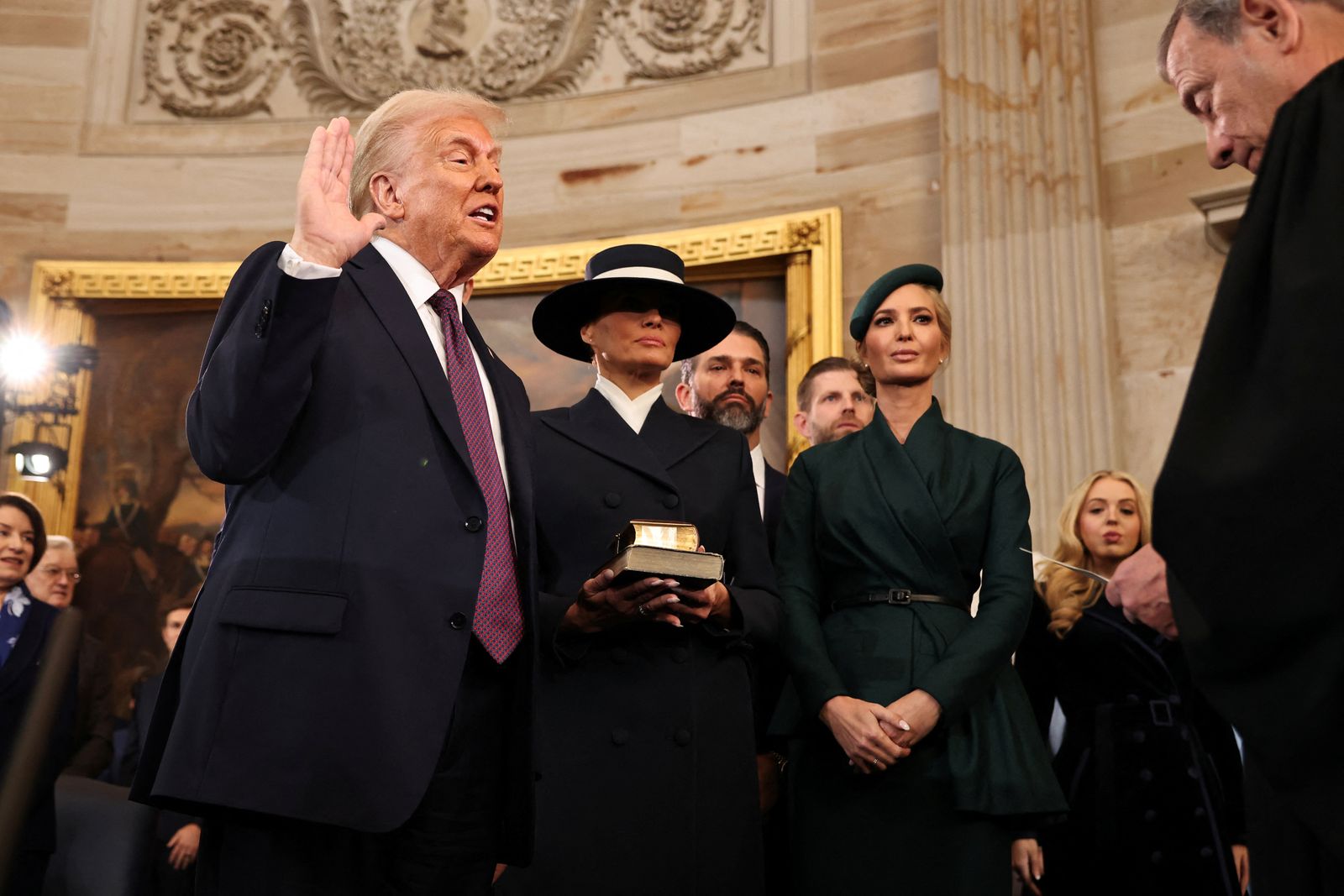 WASHINGTON, DC - JANUARY 20: U.S. President-elect Donald Trump takes the oath of office from Chief Justice John Roberts as Melania Trump, Ivanka Trump, Donald Trump Jr., Eric Trump and Tiffany Trump look on during inauguration ceremonies in the Rotunda of the U.S. Capitol on January 20, 2025 in Washington, DC. Donald Trump takes office for his second term as the 47th president of the United States.     Chip Somodevilla/Pool via REUTERS