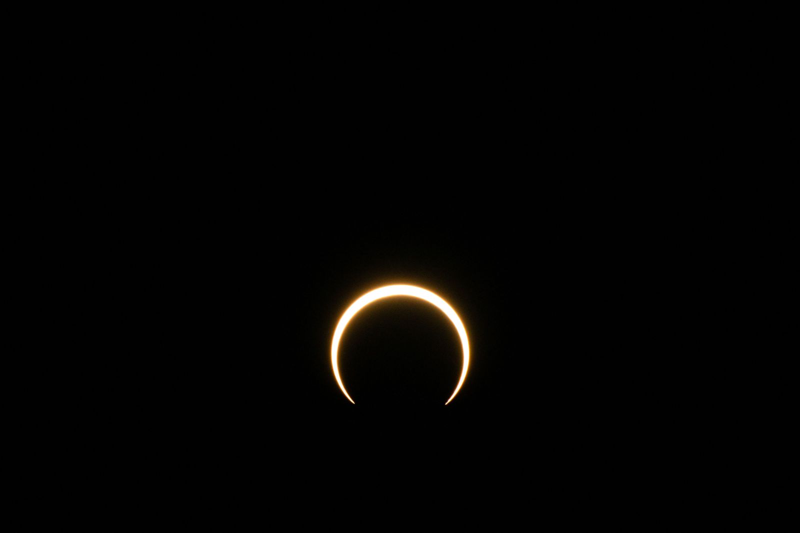 KERRVILLE, TEXAS - OCTOBER 14: The moon begins to fall below the sun's horizon during an annular solar eclipse on October 14, 2023 in Kerrville, Texas. Differing from a total solar eclipse, the moon in an annular solar eclipse covers part of the sun's light, creating the 'ring of fire' effect around the moon.   Brandon Bell/Getty Images/AFP (Photo by Brandon Bell / GETTY IMAGES NORTH AMERICA / Getty Images via AFP)