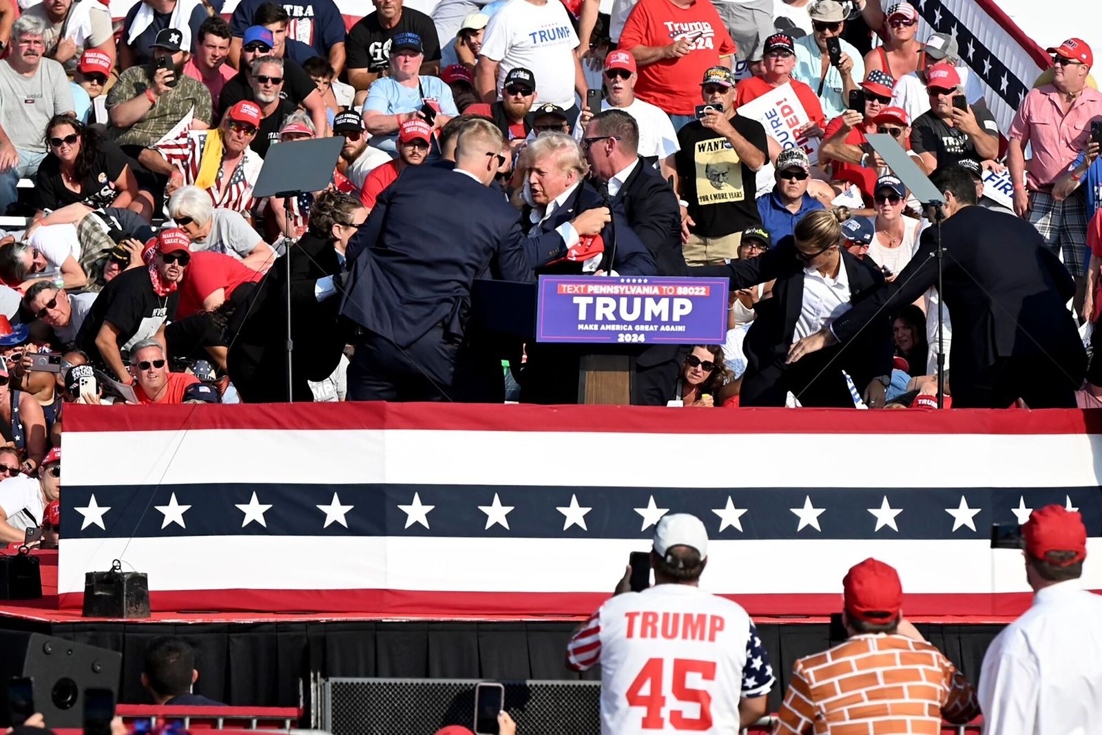 Former US President Donald Trump is surrounded by Secret Service agents during a campaign event at Butler Farm Show Inc. in Butler, Pennsylvania, US, on Saturday, July 13, 2024. Former President Donald Trump is being evaluated at a medical facility but is 'fine' after an incident where he was rushed off stage during rally in Butler, Pennsylvania, his campaign said. Photographer: Joe Appel/Bloomberg