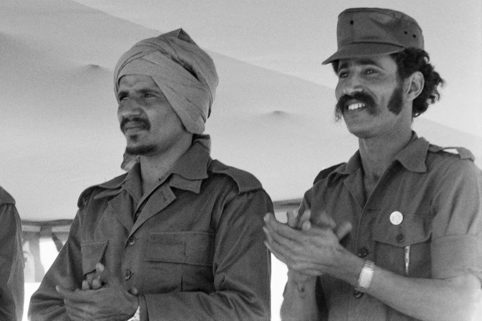 (FILES) In this file photo taken on February 28, 1978 then Defence minister Brahim Ghali (R) and Secretary General of the Polisario Front Mohamed Abdelaziz attend the 2nd anniversary of the proclamation of independence of the Sahrawi Arab Democratic Republic. - The leader of the Western Sahara independence movement, Brahim Ghali, at the heart of a diplomatic spat between Spain and Morocco will appear before a Madrid court on June 1, 2021 to answer allegations of torture. (Photo by Pierre TAILLEFER / AFP) - AFP