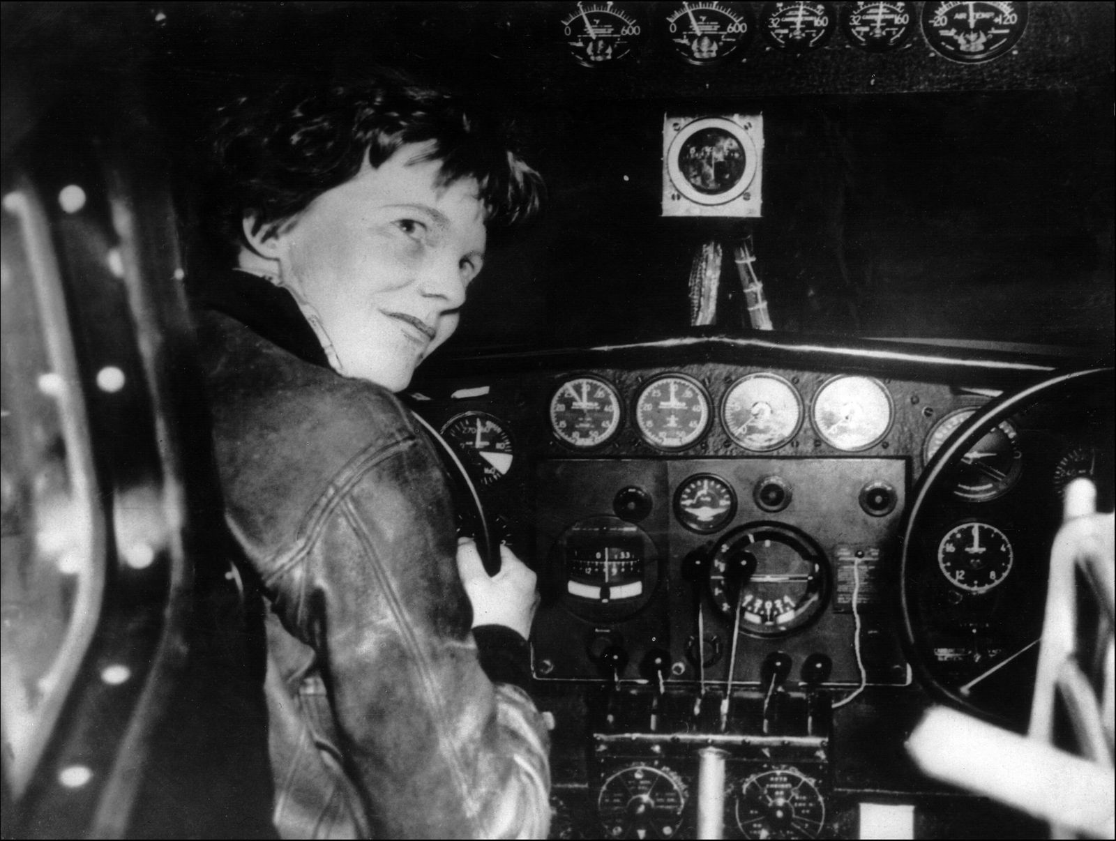 (FILES) An undated 1930's file photo shows US aviator Amelia Earhart at the controls of an aircraft in Essonne, France. A deep sea exploration company released a sonar image on January 29, 2024 they say may be the remains of the plane of Amelia Earhart, the famed American aviatrix who disappeared over the Pacific in 1937. Deep Sea Vision (DSV), a South Carolina-based firm, said the image was captured after an extensive search in an area of the Pacific to the west of Earhart's planned destination, remote Howland Island. (Photo by AFP)
