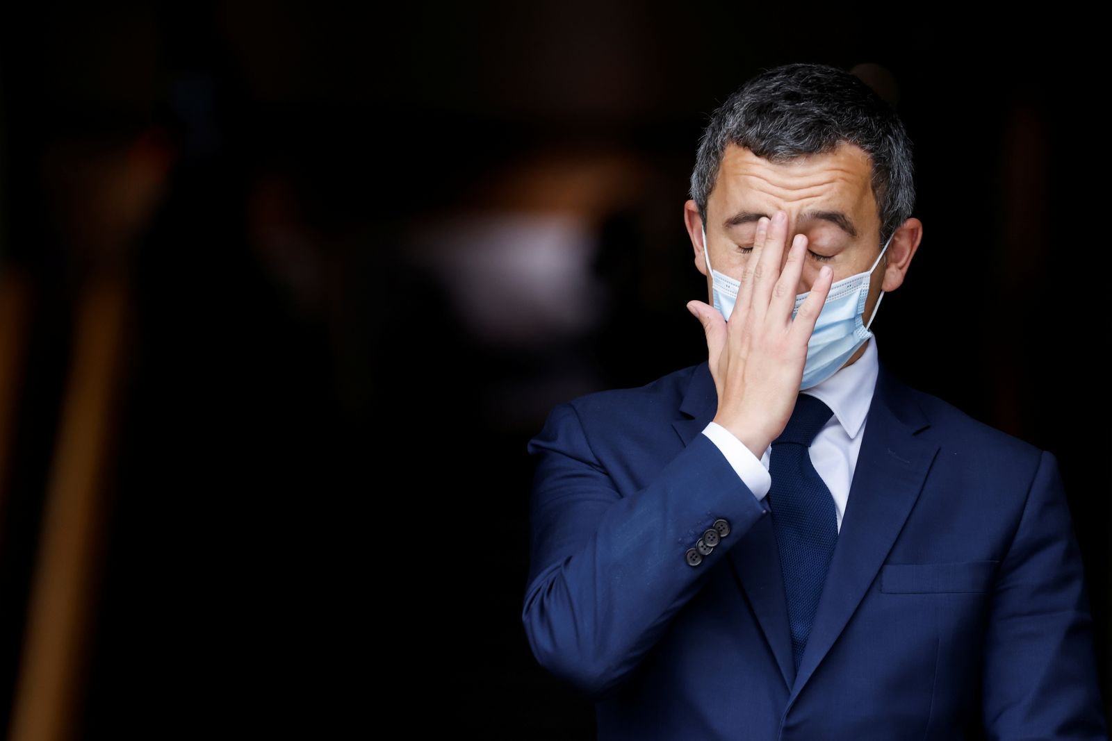 French Interior Minister Gerald Darmanin touches his face ahead of a visit of the French President Emmanuel Macron about the fight against separatism at the Seine-Saint-Denis prefecture headquarters in Bobigny - REUTERS