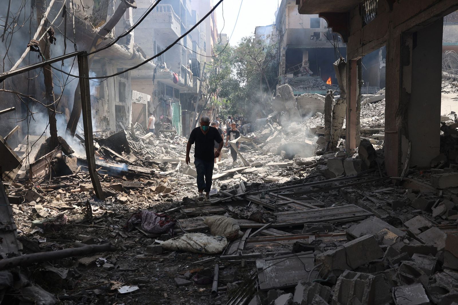 A Palestinian man wan walks on the rubble of destoryed buildings following an operations by the Israeli Special Forces in the Nuseirat camp, in the central Gaza Strip on June 8, 2024, amid the ongoing conflict between Israel and the Palestinian Hamas militant group. The Israeli military said in a statement on June 8, that their forces were 'targeting terrorist infrastructure in the area of Nuseirat'. A Gaza hospital said the Israeli strikes in central areas of the territory, including in Nuseirat camp, killed at least 15 people. (Photo by Eyad BABA / AFP)