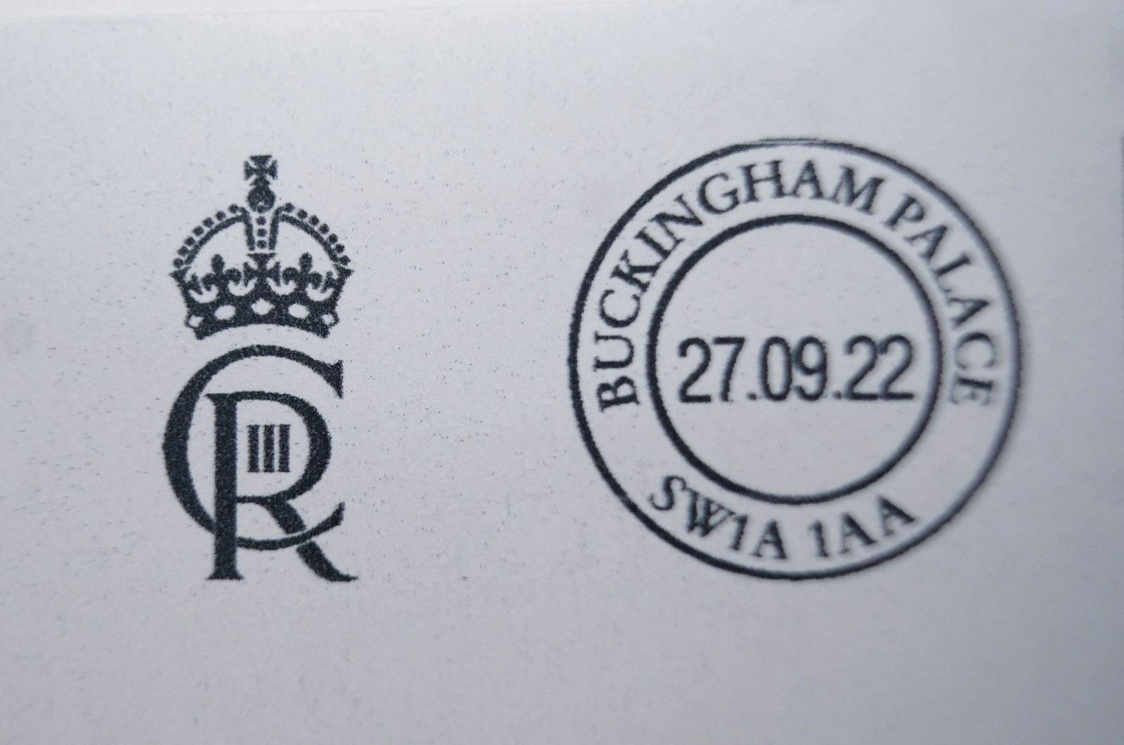 Envelopes franked with the new cypher of King Charles III 'CIIIR' are pictured after being printed in the Court Post Office at Buckingham Palace in central London on September 27, 2022 - Buckingham Palace on Monday revealed King Charles III's new royal cypher -- the monogram of his initials that will feature on government buildings, state documents and new post boxes.  His late mother Queen Elizabeth II's cypher was EIIR, standing for Elizabeth II Regina (queen in Latin). Charles's will be CIIIR for Charles III Rex (king in Latin), with the C intertwined with the R, the III within the R, and the crown above both letters. (Photo by Yui Mok / POOL / AFP) - AFP