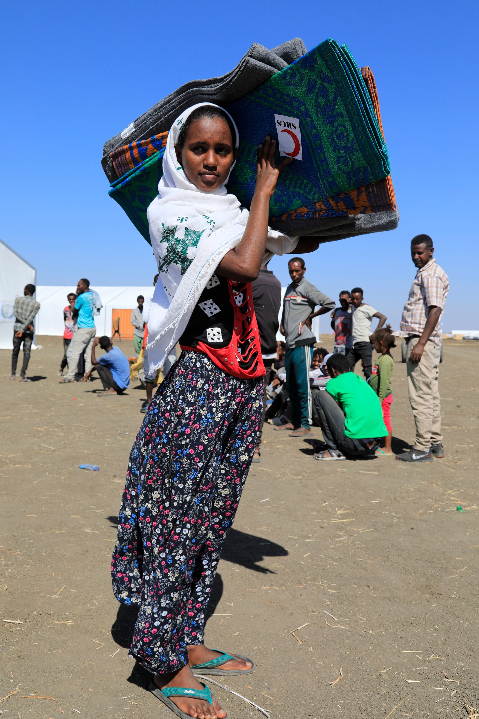 لاجئة من إقليم تيغراي تحمل حقيبة في مخيّم شرق السودان - 8 يناير 2021  - AFP