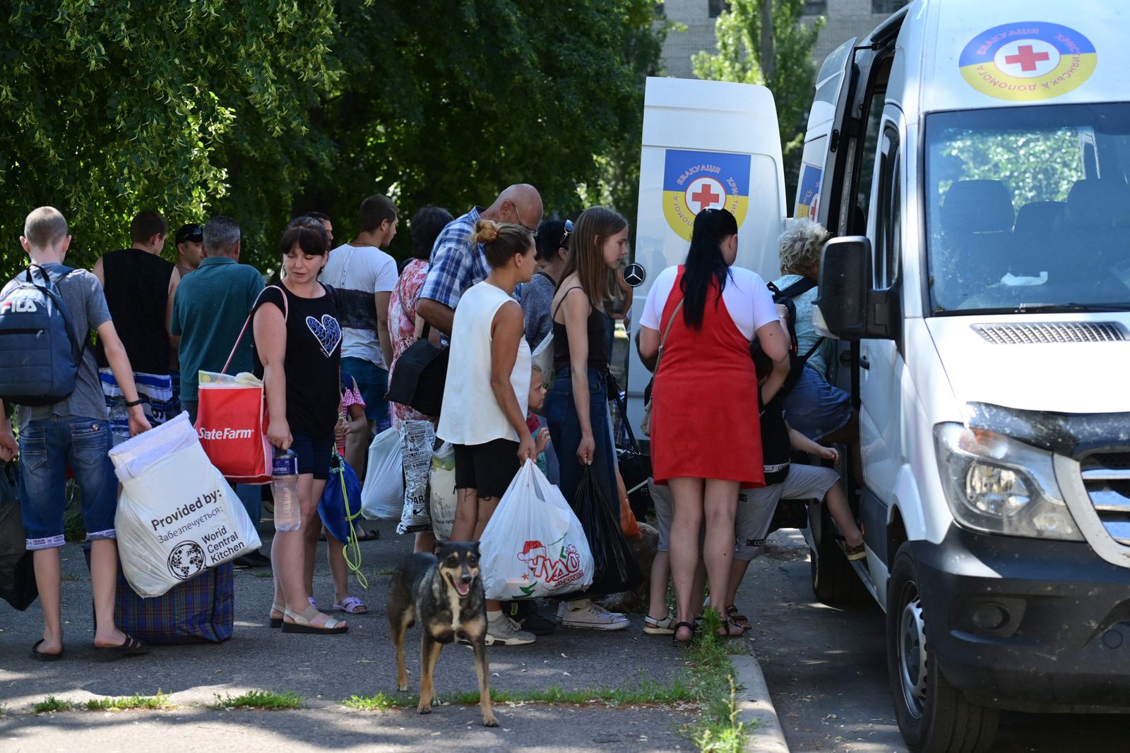 Residents of the city of Sloviansk and neighbouring towns wait for buses from the 