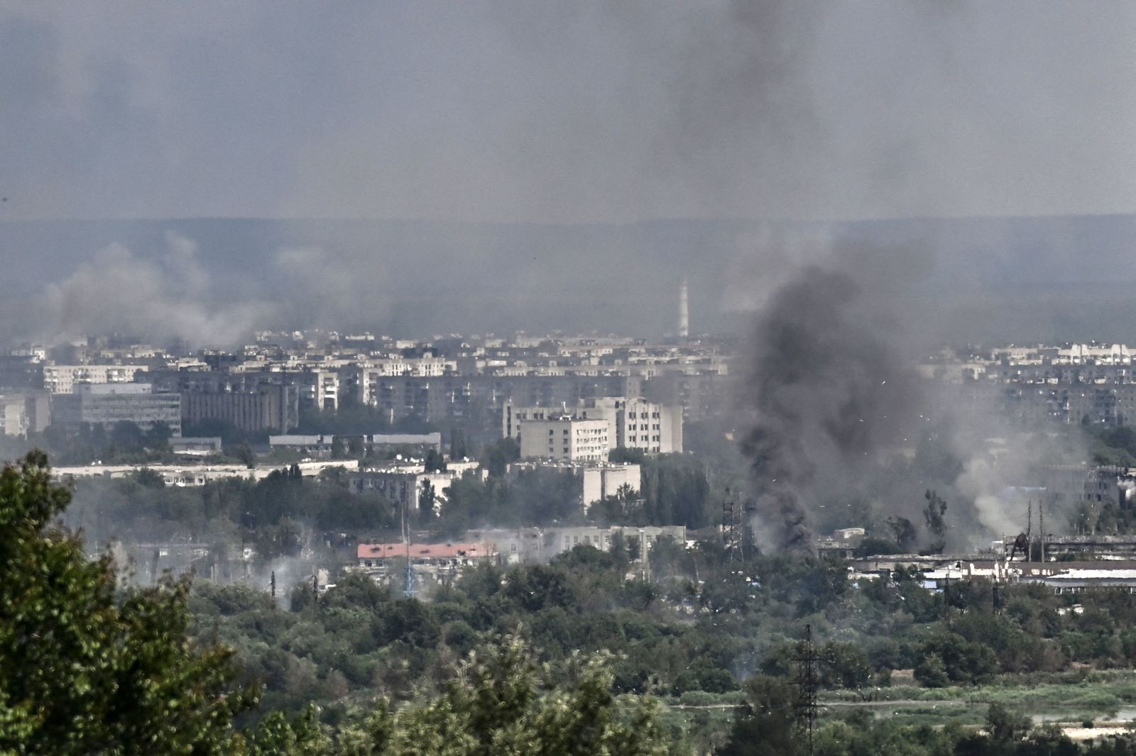 Smoke and dirt rise from the city of Severodonetsk in the eastern Ukrainian region of Donbas on June 17, 2022, as the Russian-Ukraine war enters its 114th day. (Photo by ARIS MESSINIS / AFP) - AFP