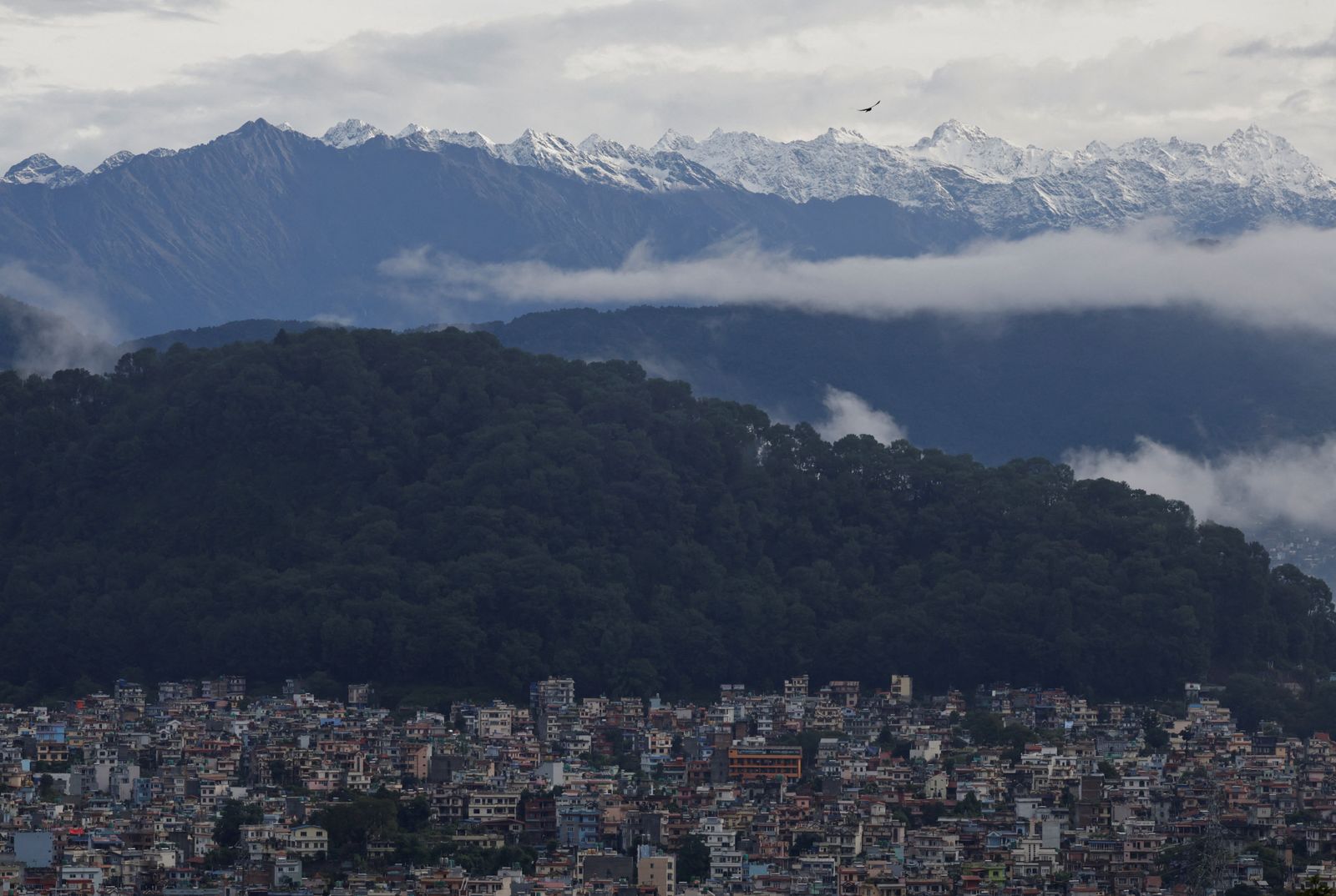 A snowcapped mountain range emerges over the valley as monsoon clouds clear following heavy rainfall in Kathmandu, Nepal, October 5, 2025. REUTERS/Navesh Chitrakar