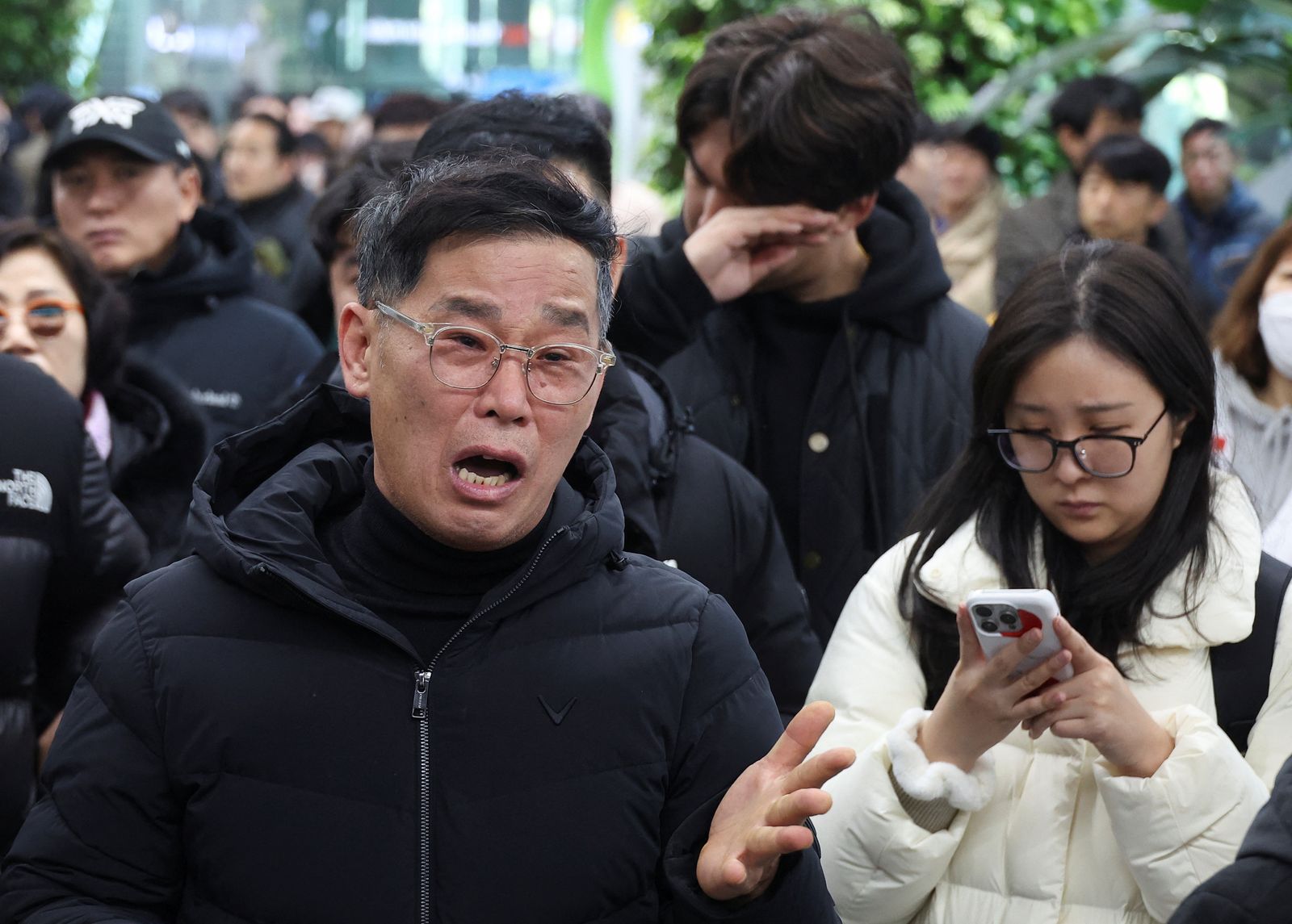 A relative of a passenger of the aircraft that crashed after it went off the runway, reacts at Muan International Airport, in Muan, South Korea, December 29, 2024. REUTERS/Kim Hong-Ji