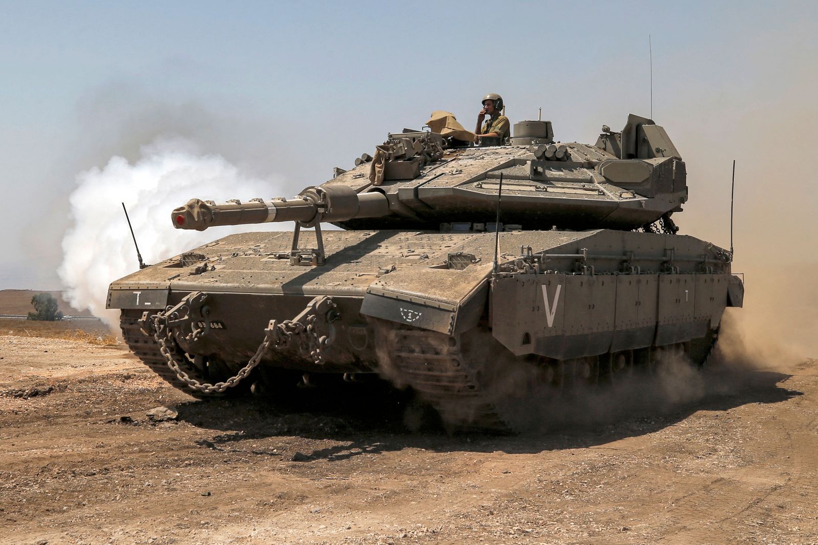An Israeli Merkava Mark IV battle tank drives during an exercise in the Israeli-annexed Golan Heights near the border with Syria on August 29, 2022. (Photo by JALAA MAREY / AFP)