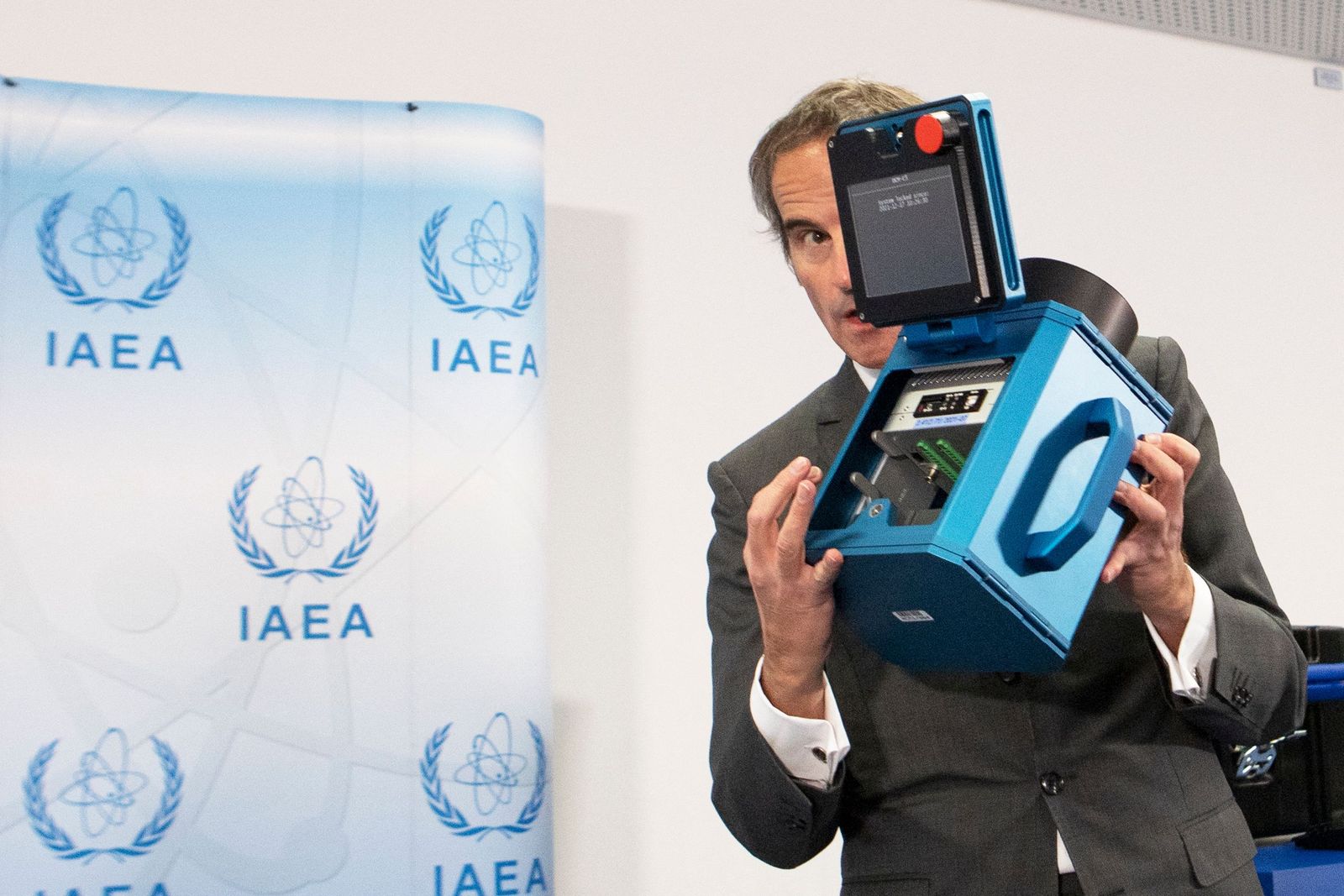Director General of the International Atomic Energy Agency (IAEA) Rafael Mariano Grossi presents a surveillance camera at the agency's headquarters in Vienna, Austria, on December 17, 2021. (Photo by ALEX HALADA / AFP) - AFP