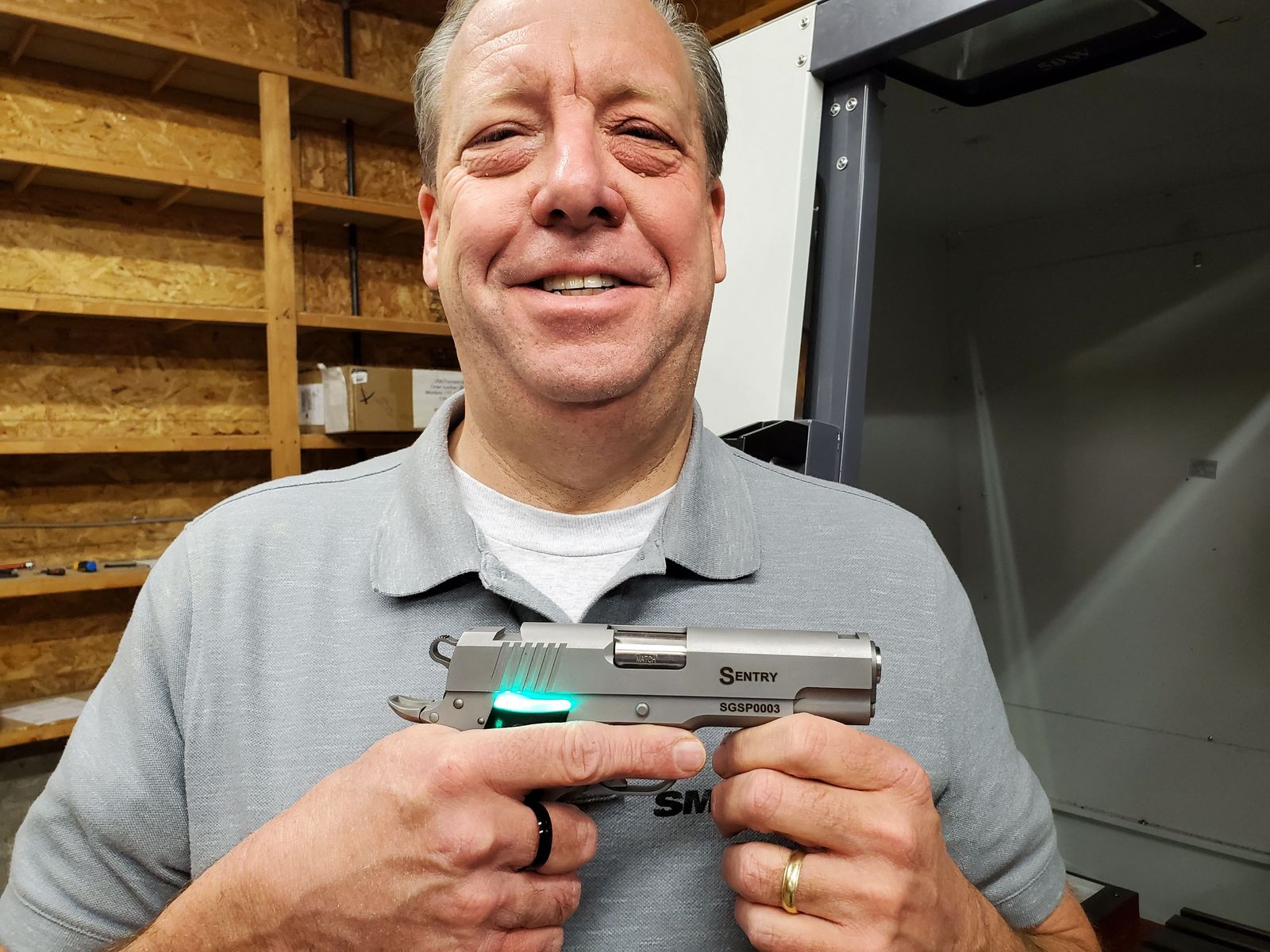 This undated handout photo courtesy of SmartGunz, LLC, shows company President G. Thomas (�Tom�) Holland II posing while he holds his product in Baldwin City, Kansas. - 