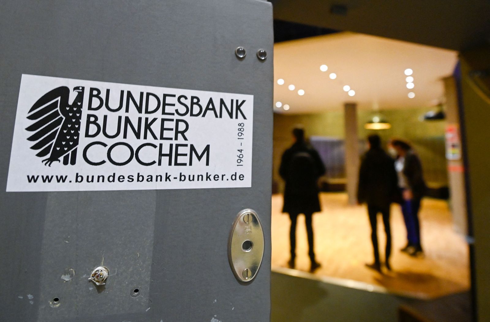 Visitors are seen in a former vault of the Bundesbank Bunker Museum in Cochem, western Germany on February 8, 2022. - The Bundesbank Bunker was a bunker of the German Federal Bank in Cochem for the storage of an emergency currency. From 1964 to 1988, up to 15 billion marks were stored in the top-secret facility to protect Germany from a national economic crisis in the event of hyperinflation caused by the Cold War. (Photo by Ina FASSBENDER / AFP) - AFP