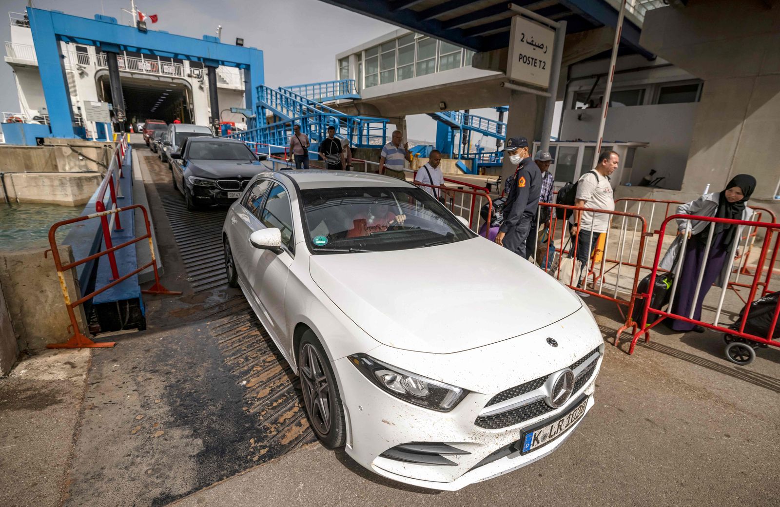 Passengers leave a ferry bound comming from Algeciras after their arrival at the Moroccan port of Tangiers on June 15, 2022. - Thousands of Moroccan nationals working and living in Europe pass through the Strait of Gibraltar as they return to spend summer holidays in Morocco. (Photo by FADEL SENNA / AFP) - AFP