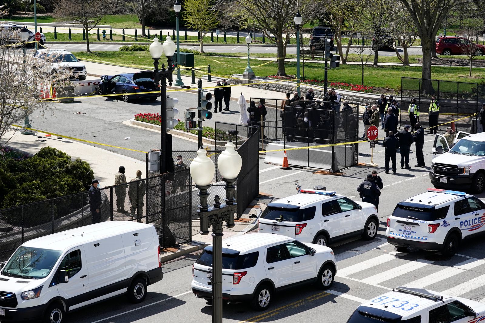 Police officers gather near a car that crashed into a barrier on Capitol Hill in Washington, Friday, April 2, 2021. (AP Photo/J. Scott Applewhite) - AP