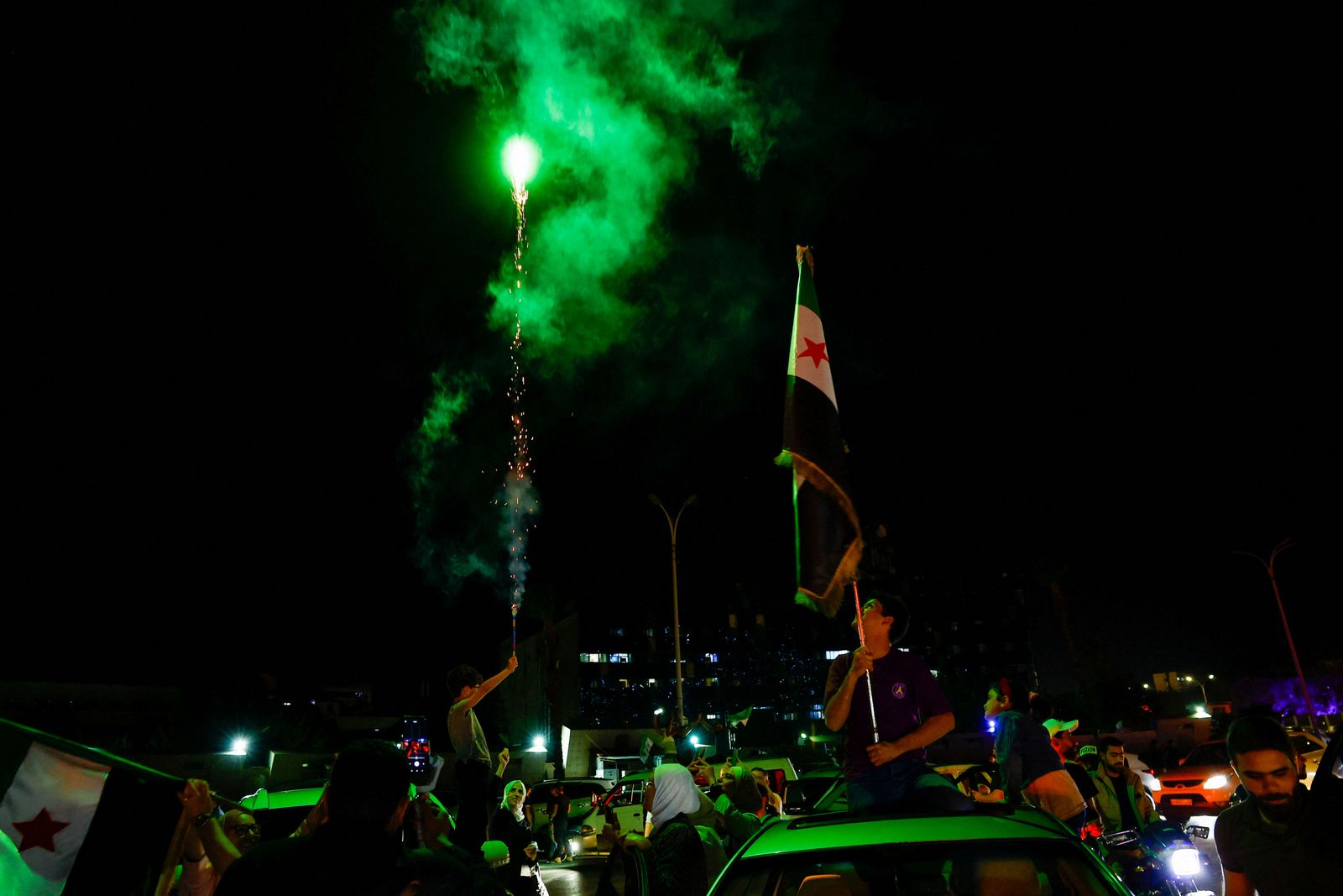 People celebrate after U.S. President Donald Trump said on Tuesday he would order the lifting of sanctions on Syria, in Damascus, Syria May 13 , 2025. REUTERS/Yamam Al Shaar