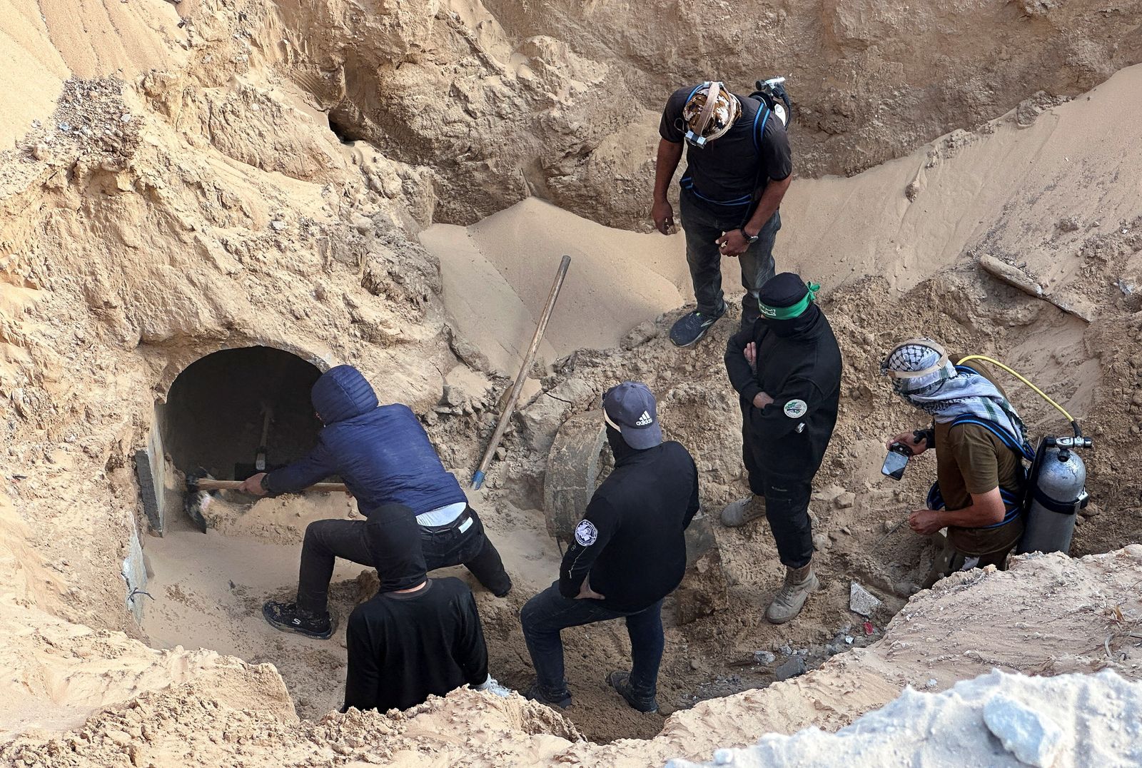People work at a site where searches for deceased hostages, kidnapped by Hamas during the October 7, 2023, attack on Israel, are underway, amid a ceasefire between Israel and Hamas, in Khan Younis, southern Gaza Strip, October 28, 2025. REUTERS/Haseeb Alwazeer