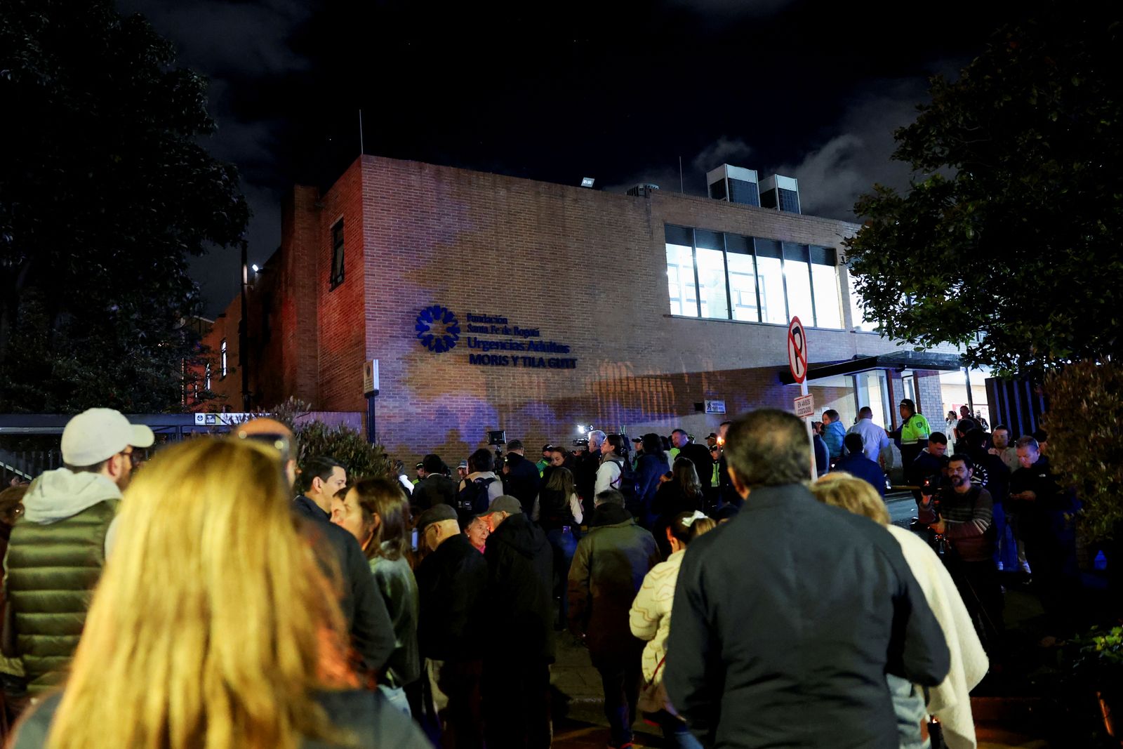 People gather outside Santa Fe Foundation hospital, where Colombian Senator Miguel Uribe Turbay of the opposition Democratic Center party was shifted to from another hospital, after he was shot during a campaign event, in Bogota, Colombia, June 7, 2025. REUTERS/Luisa Gonzalez