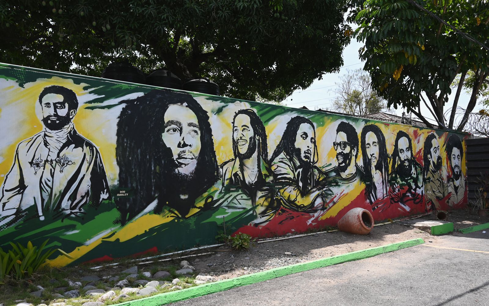 (FILES) In this file photo a mural depicting Ethiopian Emperor Haile Selassie I, Jamaican Reggae legend Bob Marley and his seven sons is seen on the grounds of the Bob Marley Museum in Kingston, Jamaica, on May 17, 2019. - Reggae legend Bunny Wailer, who co-founded The Wailers with Bob Marley in the 1960s, died on March 2, 2021 in Kingston at the age of 73, the Jamaican government said. No cause of death was given but the culture ministry said Wailer -- his real name was Neville Livingstone -- had been hospitalized since December.Wailer was the last surviving original member of the Wailers after Marley died of cancer in 1981, and Peter Tosh was murdered in 1987. (Photo by Angela Weiss / AFP) - AFP