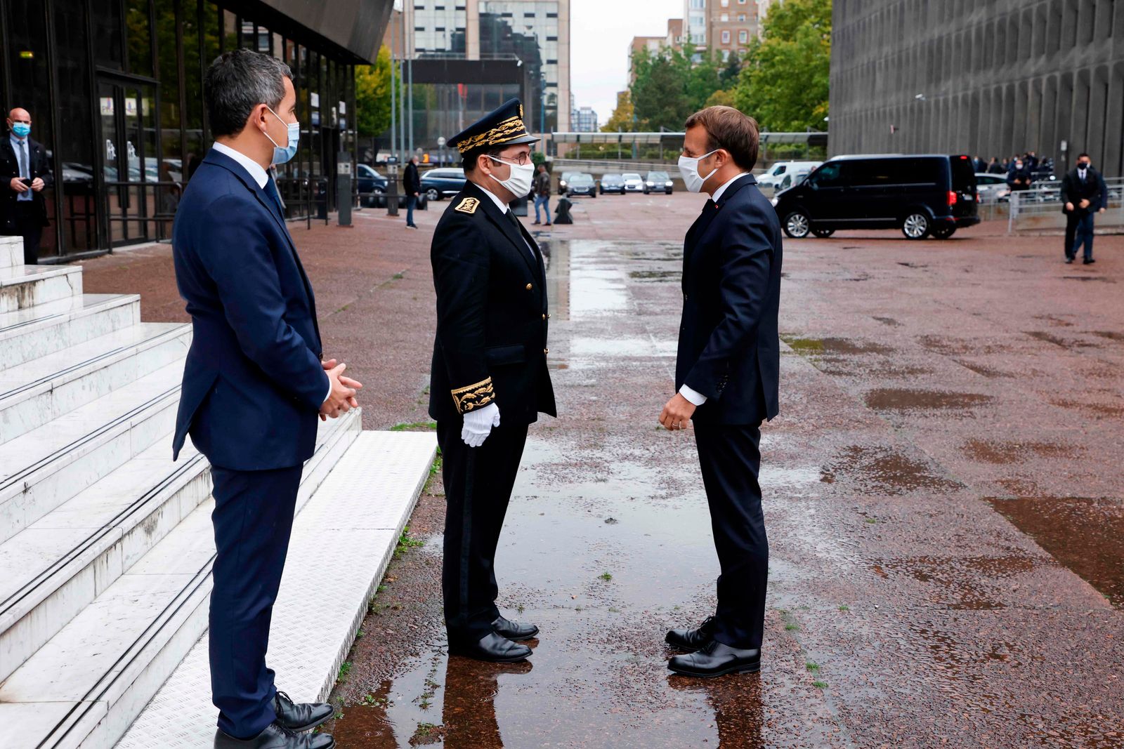 Seine-Saint-Denis' prefect Georges-Francois Leclerc (C) and French Interior Minister Gerald Darmanin (L) welcome French president Emmanuel Macron during a visit about the fight against separatism at the Seine Saint Denis prefecture headquarters in Bobigny, near Paris, on October 20, 2020. (Photo by Ludovic MARIN / POOL / AFP) - AFP