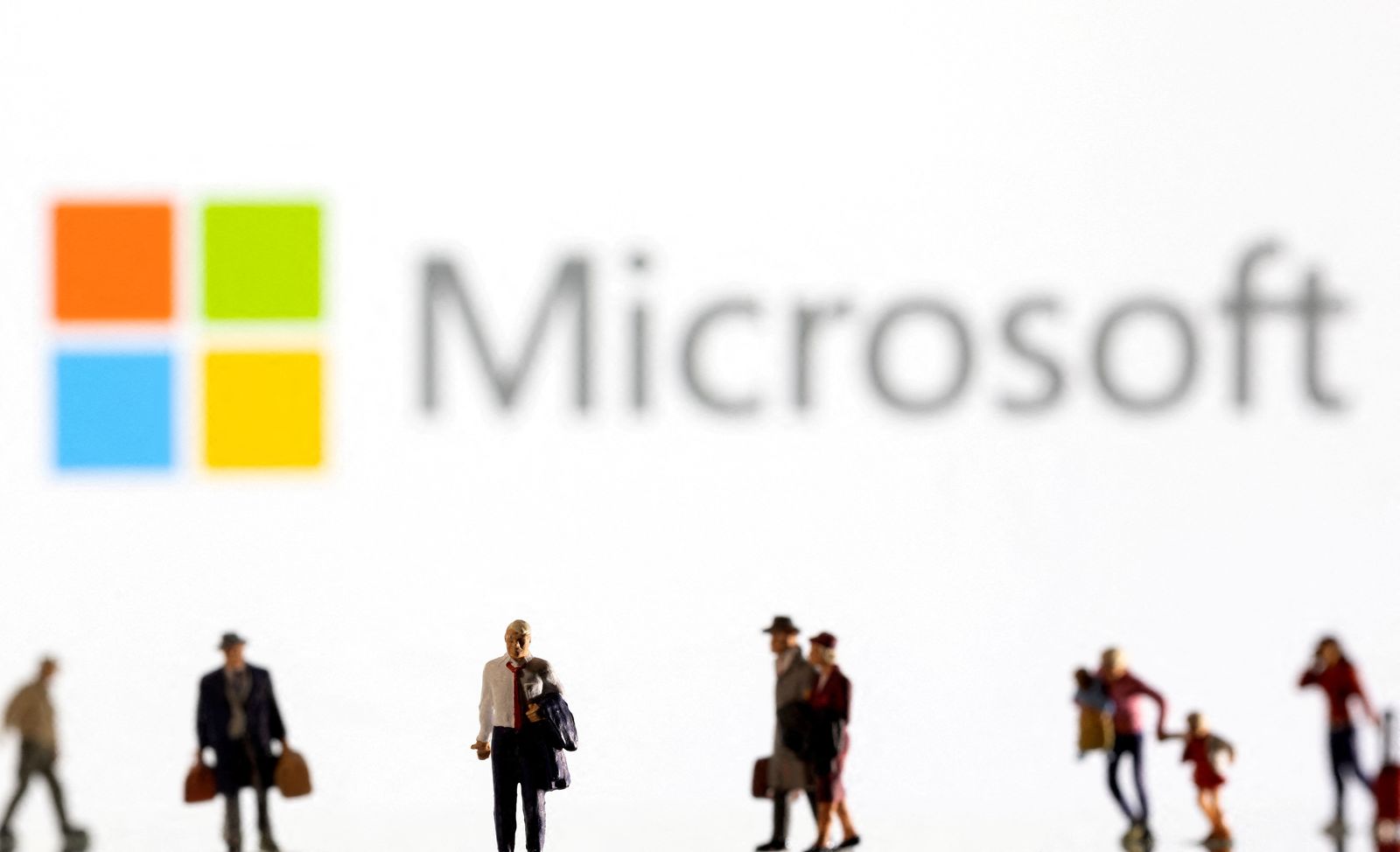 FILE PHOTO: Illustration shows small figurines and displayed Microsoft logo - REUTERS