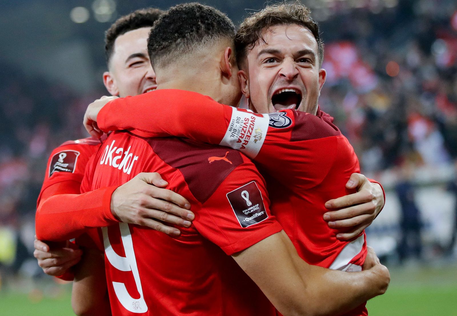Swiss' midfielder Noah Okafor (C) is congratulated by team mates after scoring a goal during the FIFA 2022 World Cup qualifying group C football match between Switzerland and Bulgaria at the Swissporarena in Lucerne. (Photo by STEFAN WERMUTH / AFP) - AFP